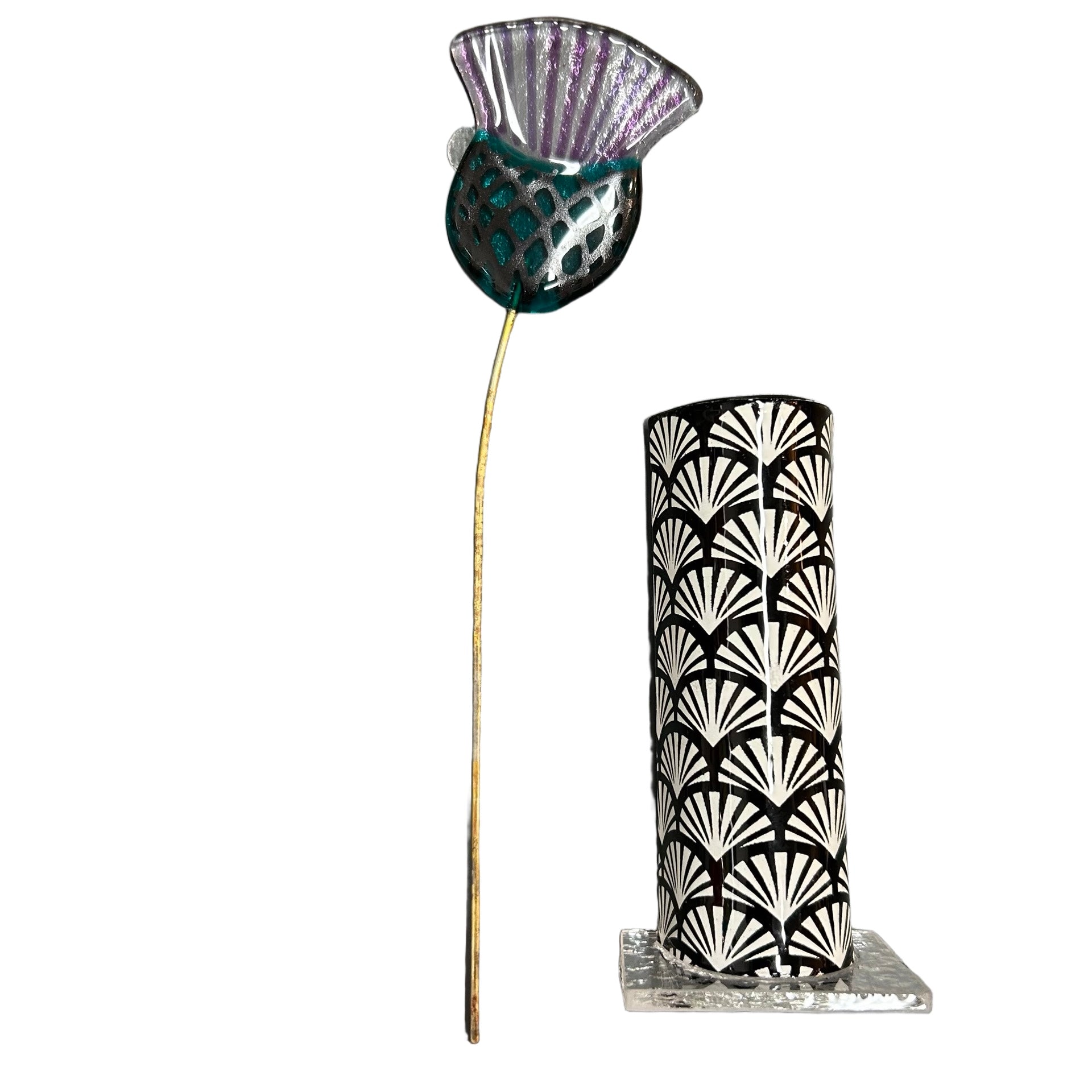 Decorative vase with black and white pattern and a glass thistle on a white background.