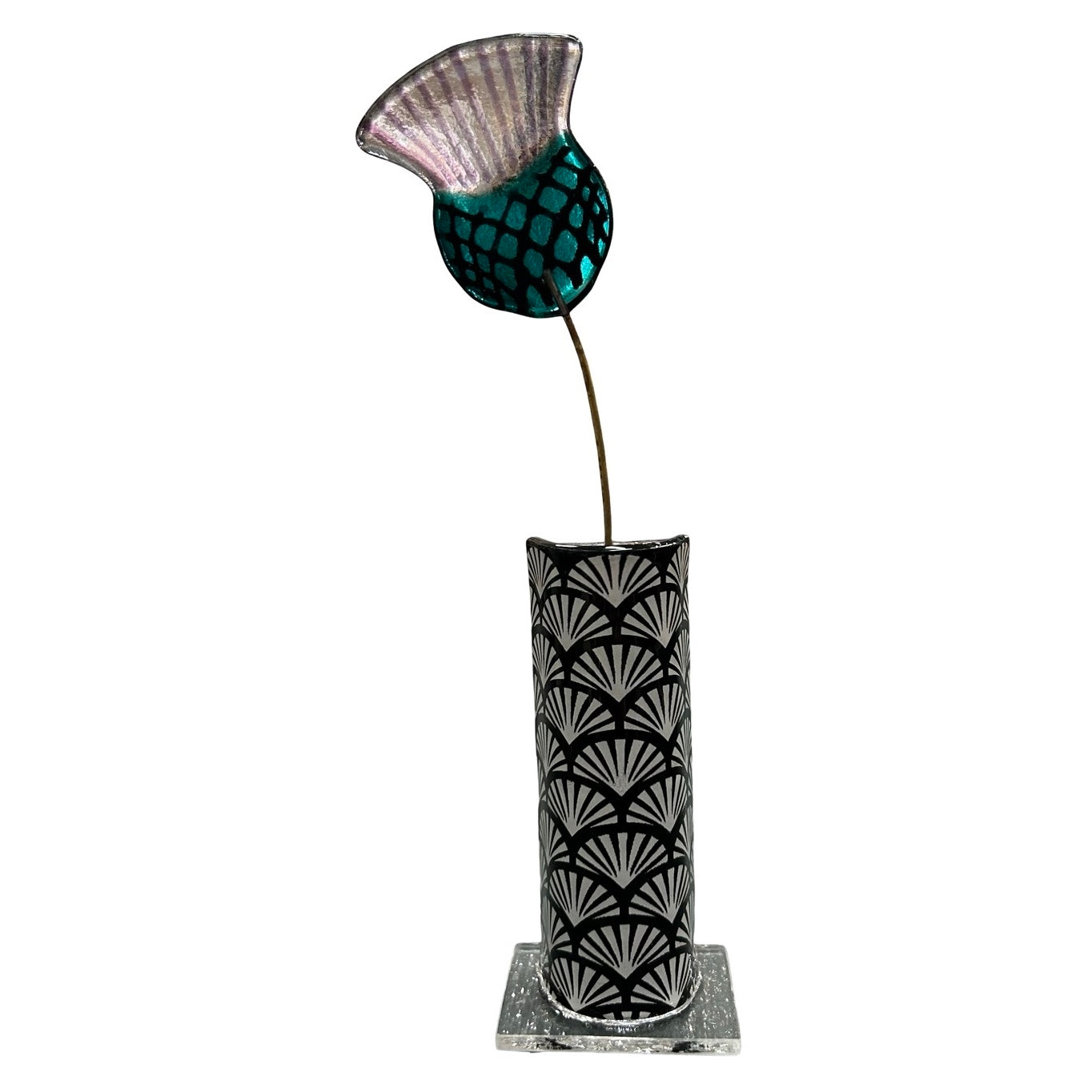 Decorative vase with a leaf pattern and a glass thistle on a white background.