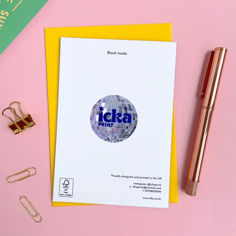 White card with 'icka print' logo on a pink background with a pen and paper clips.