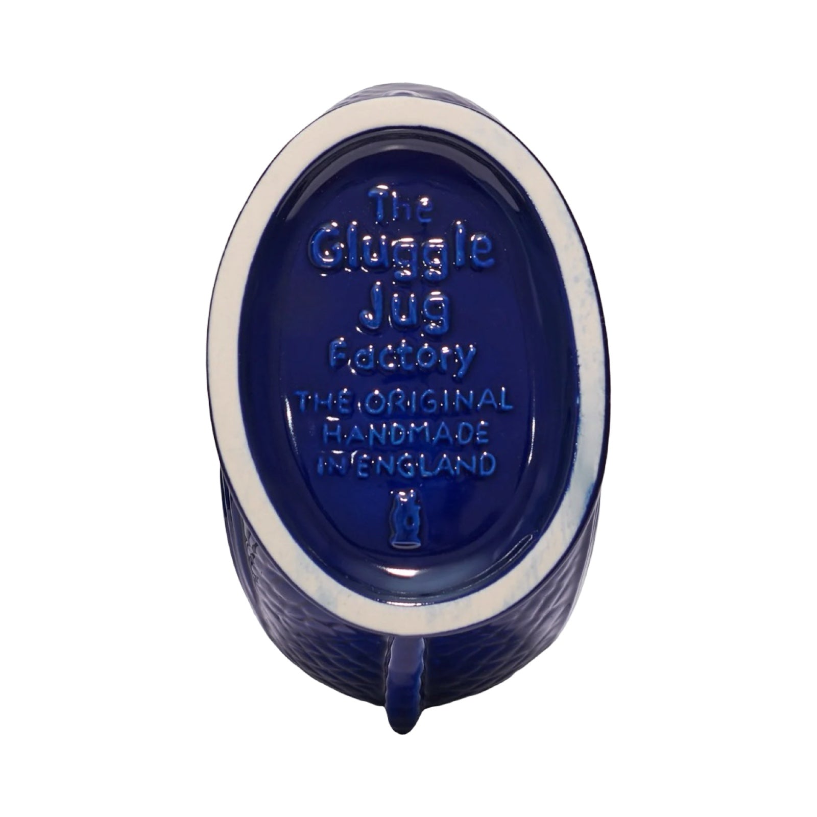 The bottom of a cobalt blue fish shaped gluggle jug.