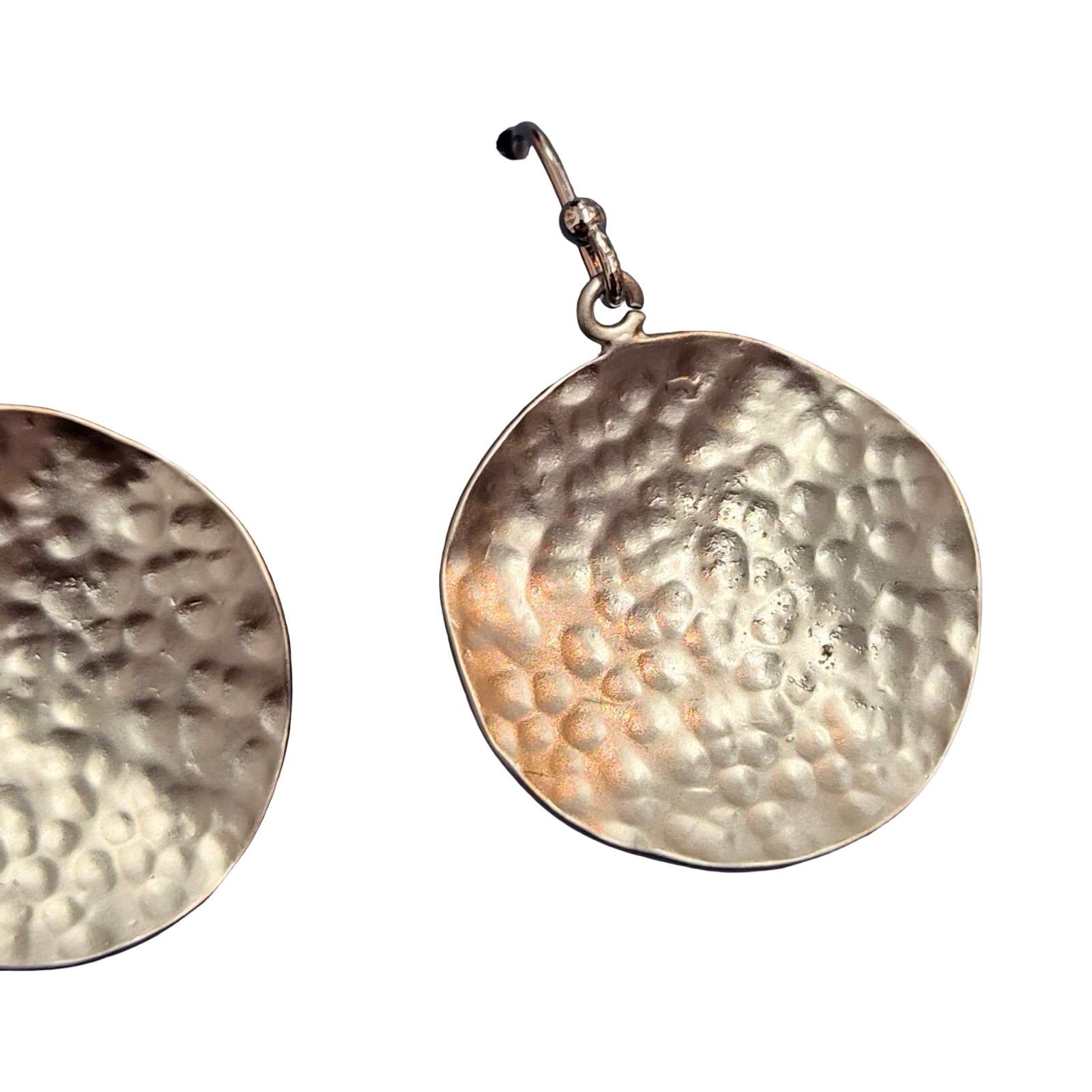 Hammered gold earring on a white background.