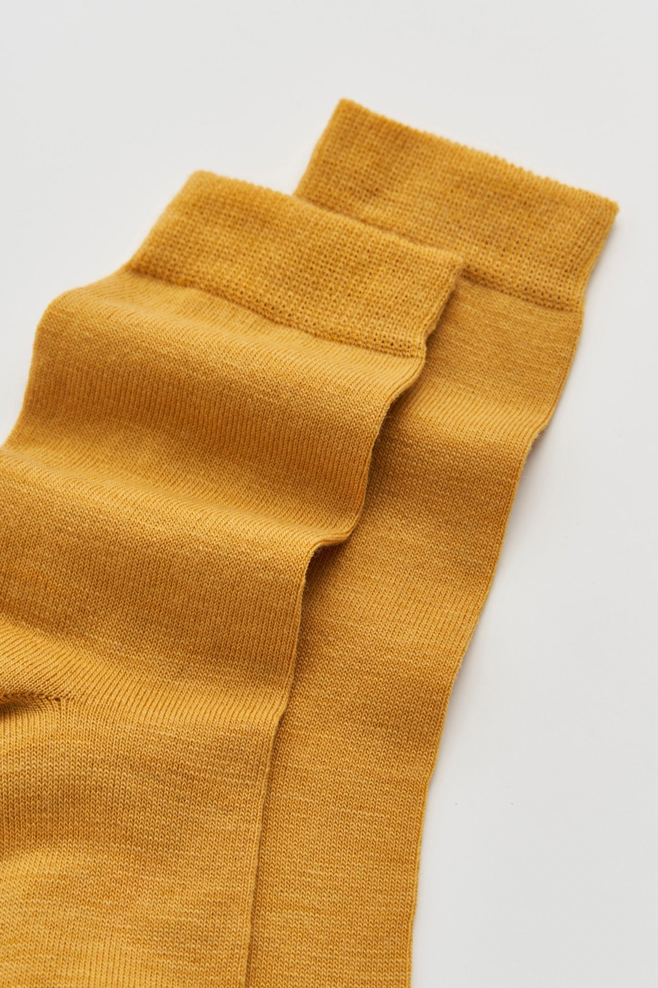 Top of a pair of golden yellow socks.