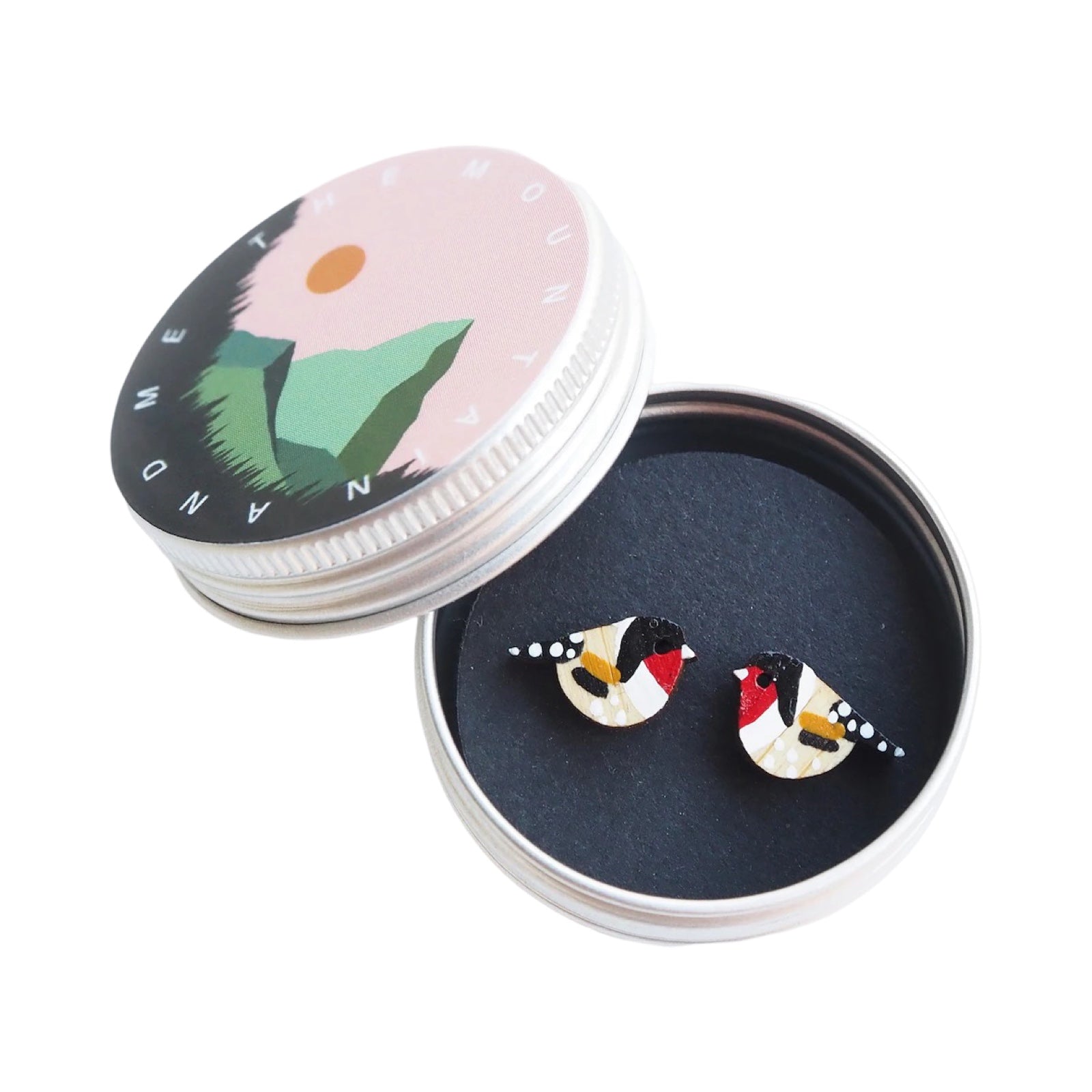 Red, white and black goldfinch bird-shaped stud earrings in a small metal tin.