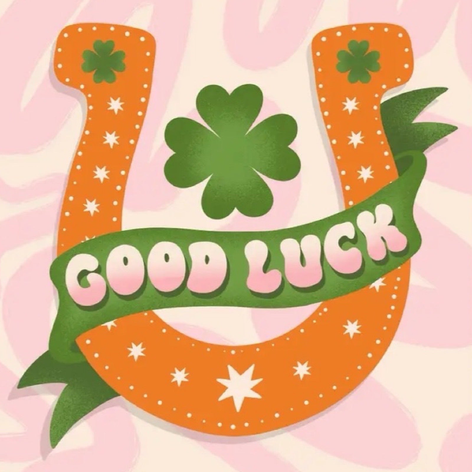 Illustration of a clover and 'Good Luck' text on a pink background.