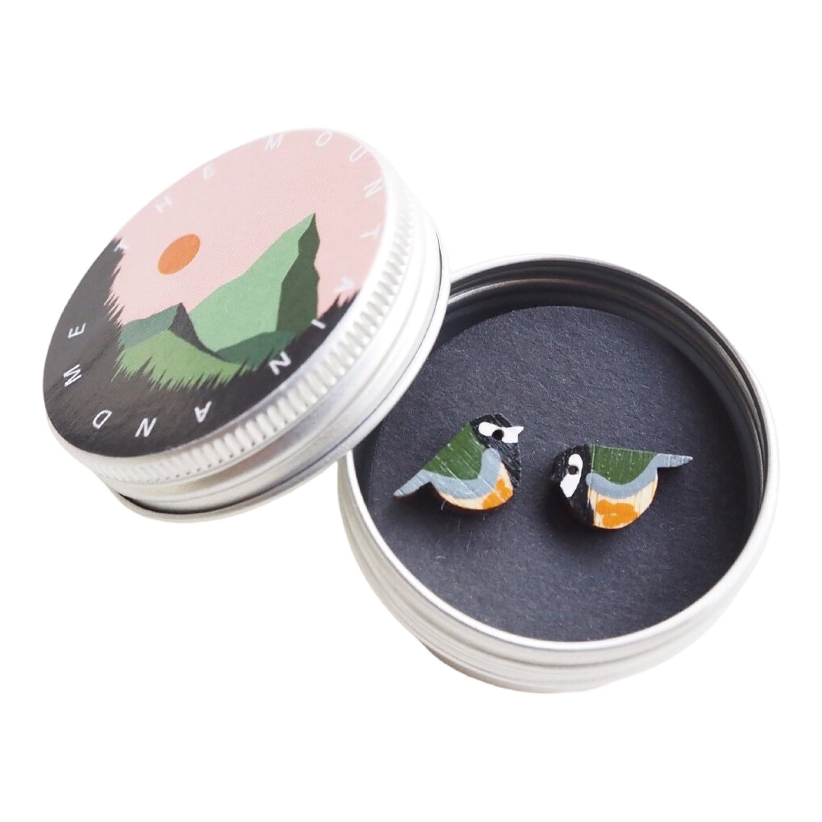 Green and mustard great tit bird-shaped stud earrings in a small metal tin.