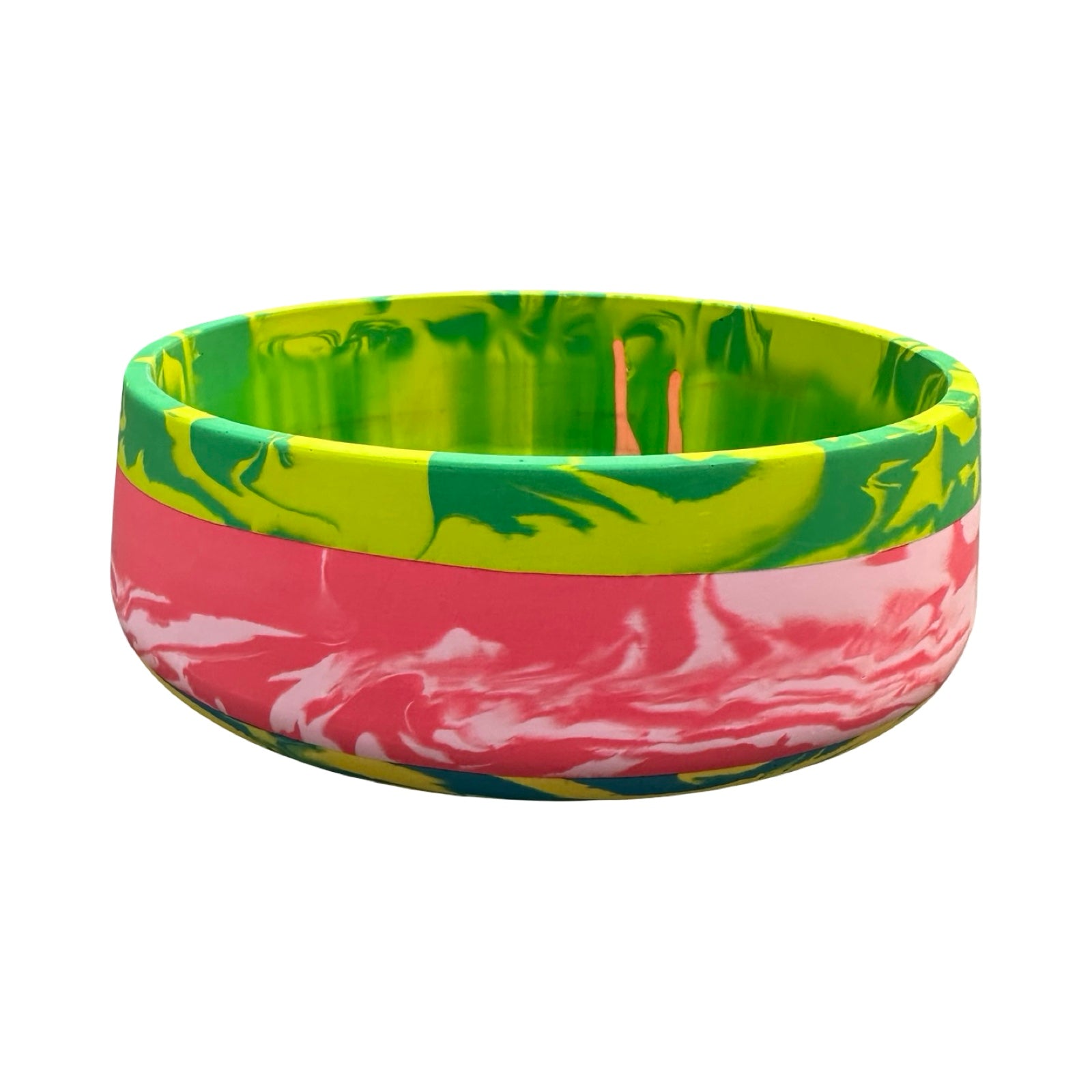 Colourful tie-dye bowl with green and pink patterns on a white background.