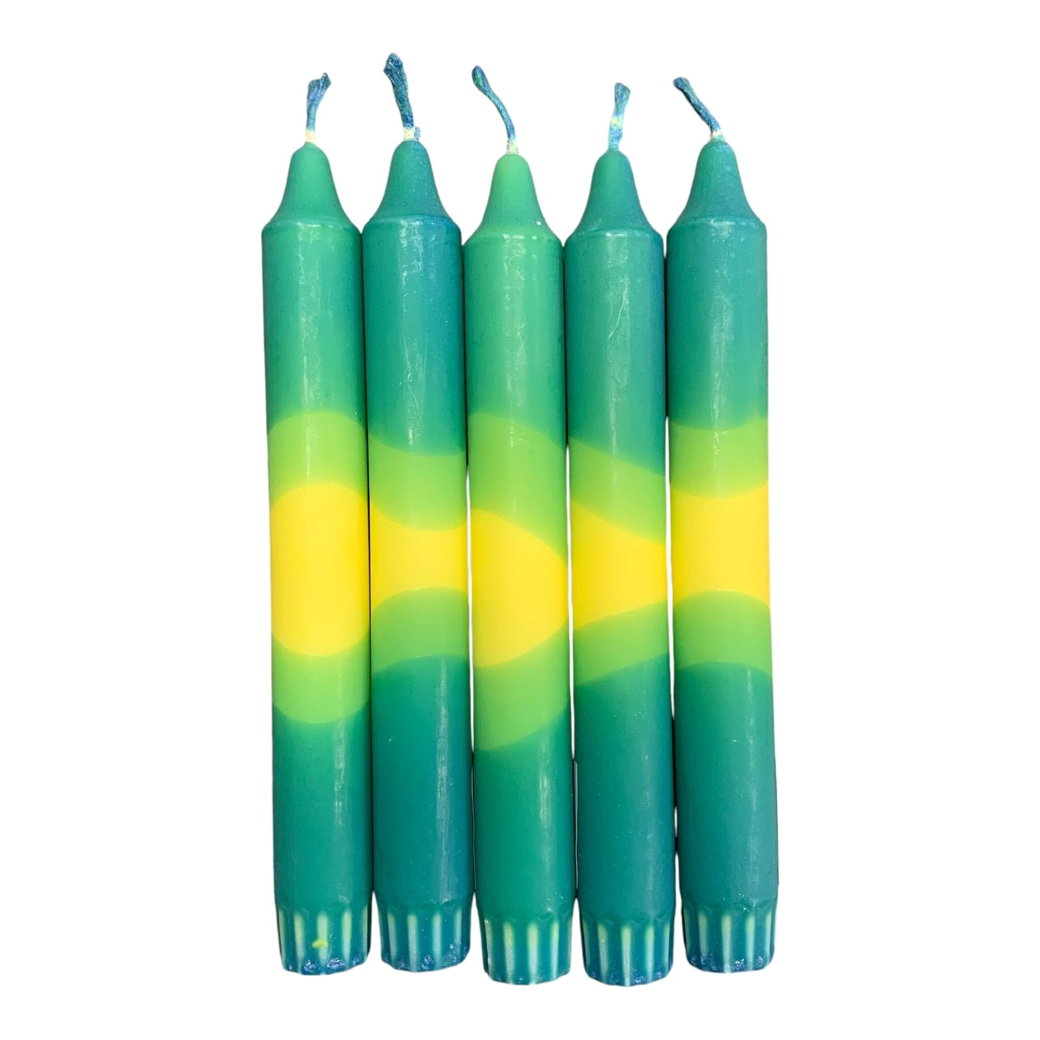 A row of 5 handmade dinner candles with a green base, a yellow centre, and a green top.