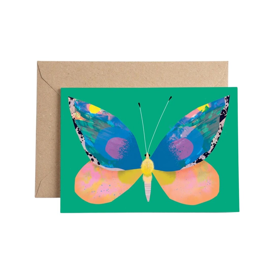 Art card featuring a gorgeous illustration of a blue and pink butterfly on a green background. 