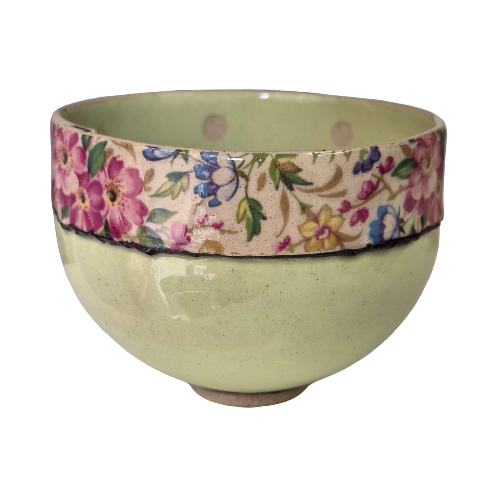 Ceramic bowl with floral patterned band on a white background.