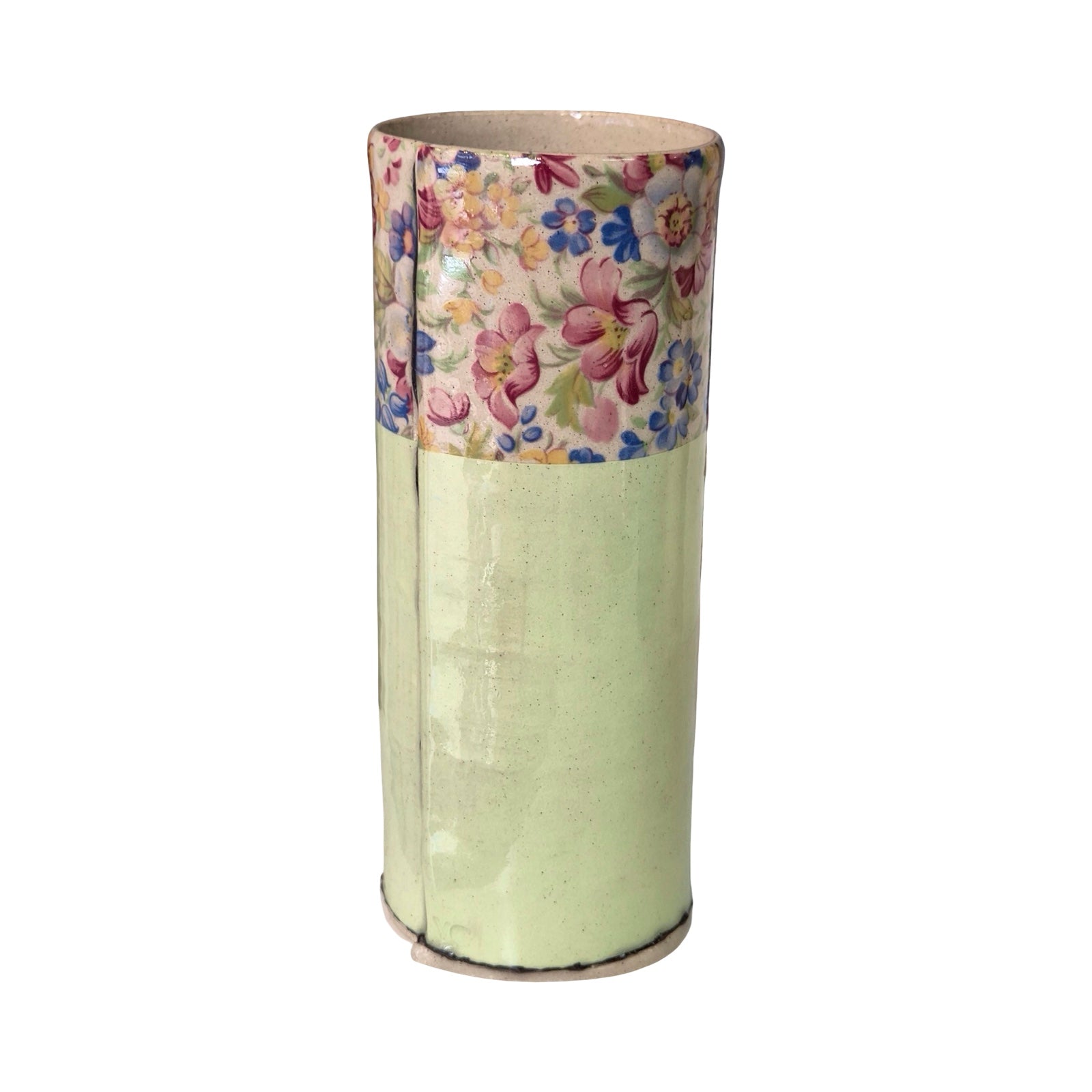 Cylindrical vase with floral patterned top on a white background.