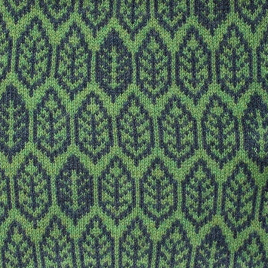 A super soft and cosy 100% lambswool knitted snood in a leaf design in shades of green.