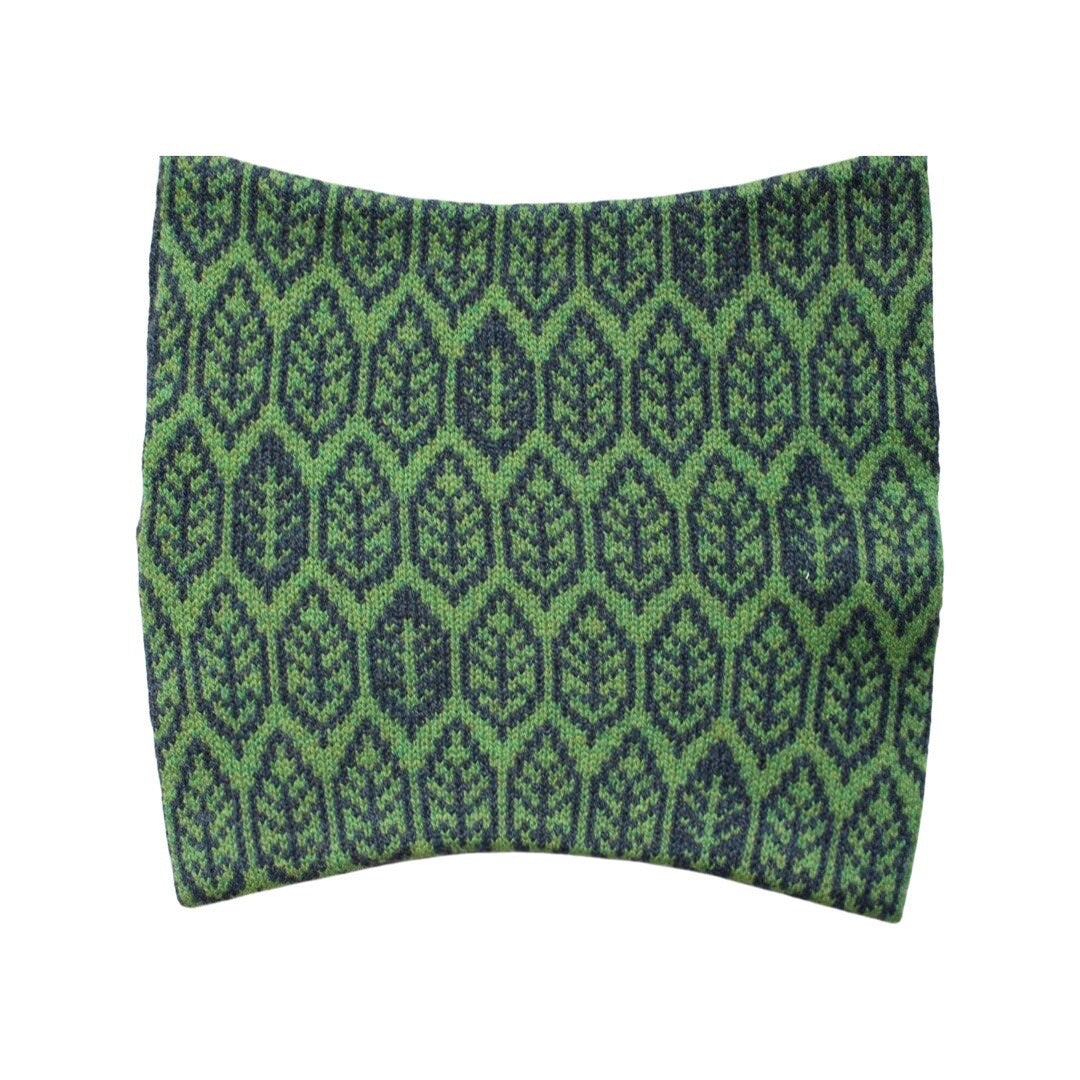 A super soft and cosy 100% lambswool knitted snood in a leaf design in shades of green.