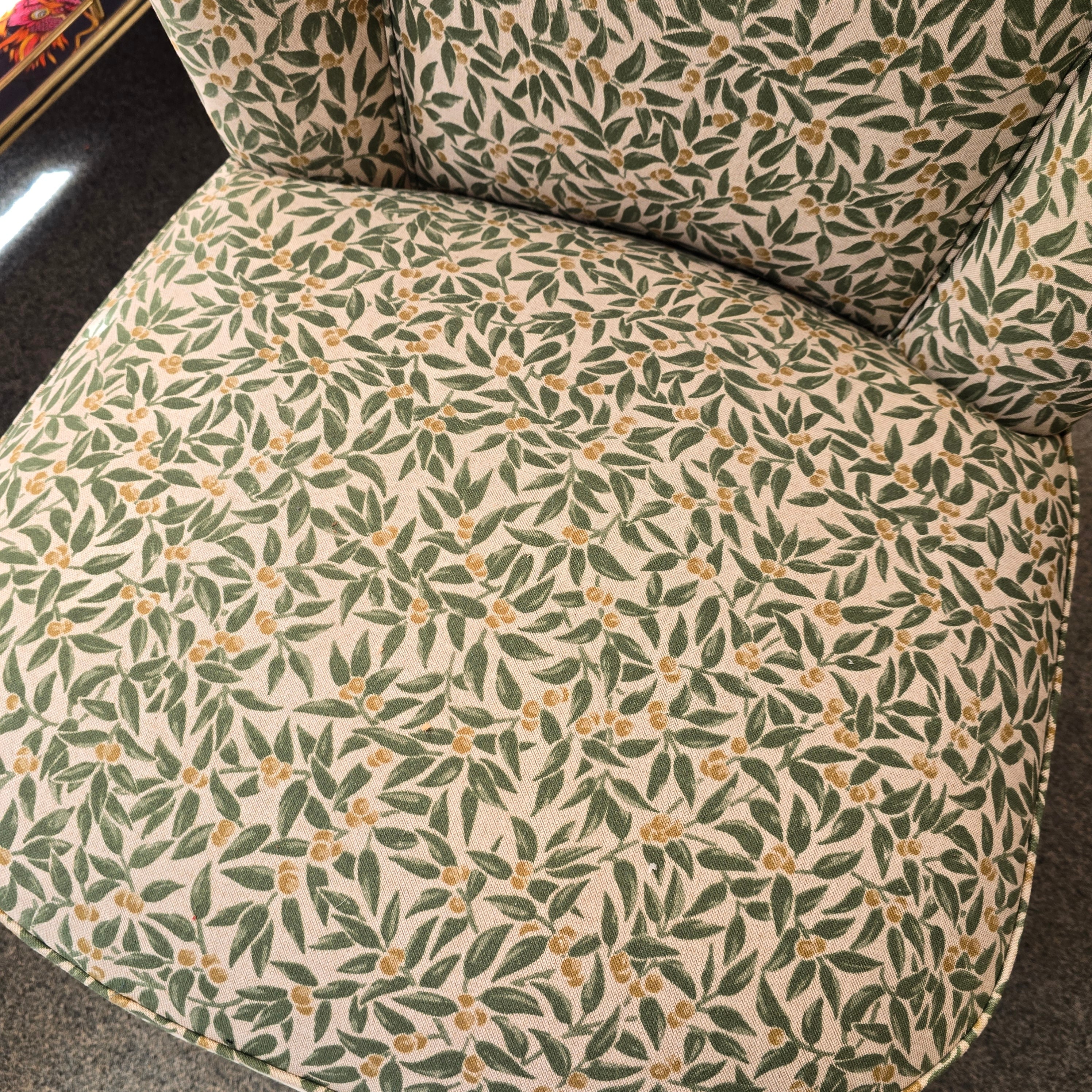 A fabulous cocktail chair covered in beautiful green foliage cotton fabric with mahogany legs. 