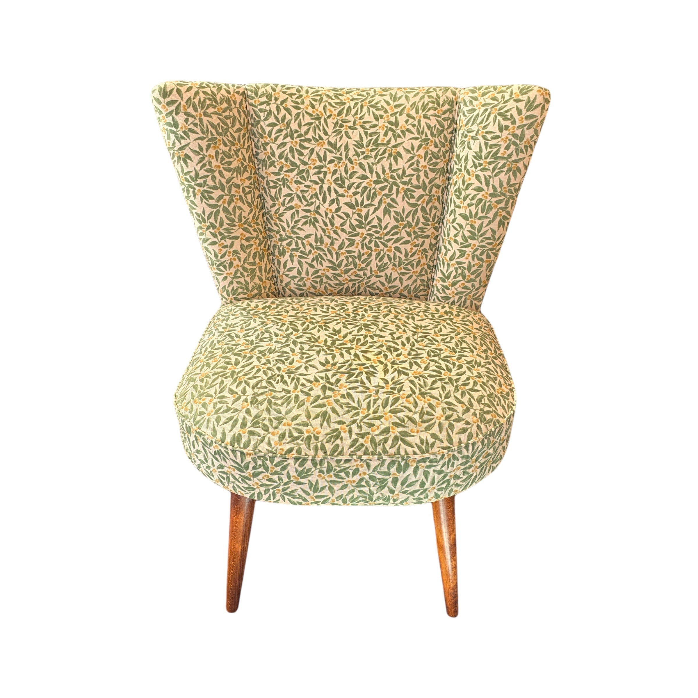 A fabulous cocktail chair covered in beautiful green foliage cotton fabric with mahogany legs. 