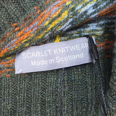 This green, orange, blue and yellow striped woollen hat is handmade using only the softest Scottish spun lambswool.