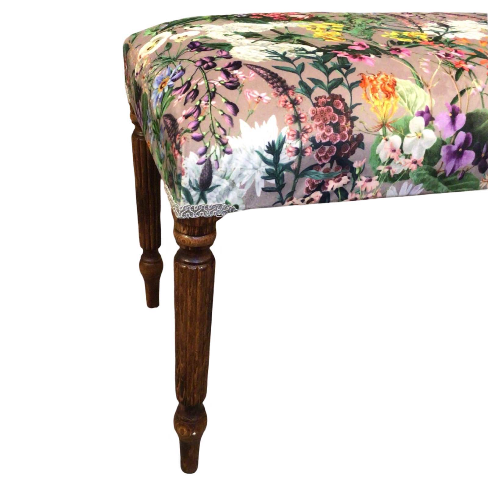 This bench is covered in luxurious grey velvet fabric with bright colourful flowers, finished with cream binding and mahogany legs.