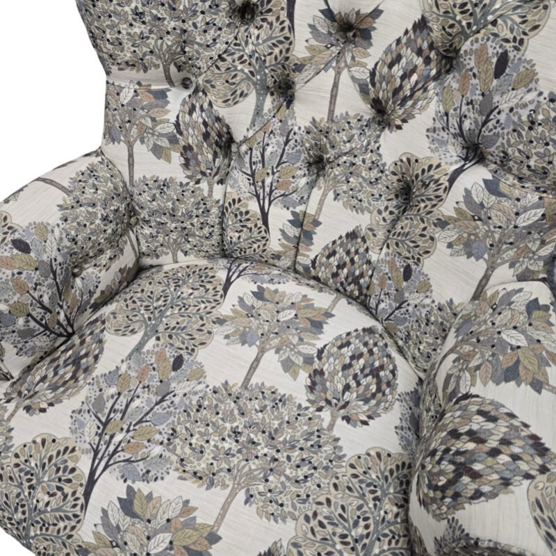 A hand-crafted occasional armchair covered in digitally printed cream cotton/linen blend fabric with a grey and beige tree design. 
