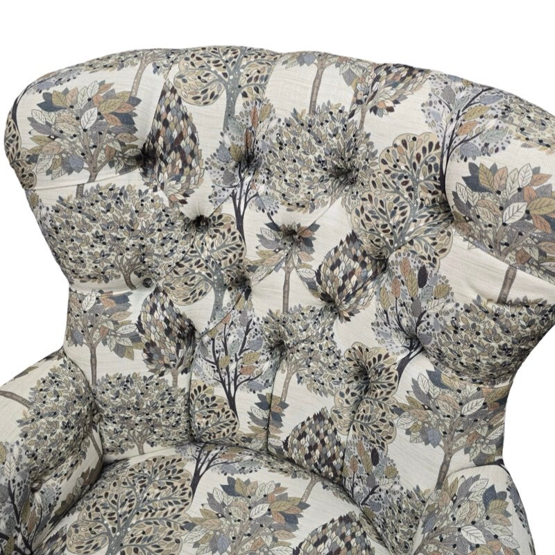 A hand-crafted occasional armchair covered in digitally printed cream cotton/linen blend fabric with a grey and beige tree design. 