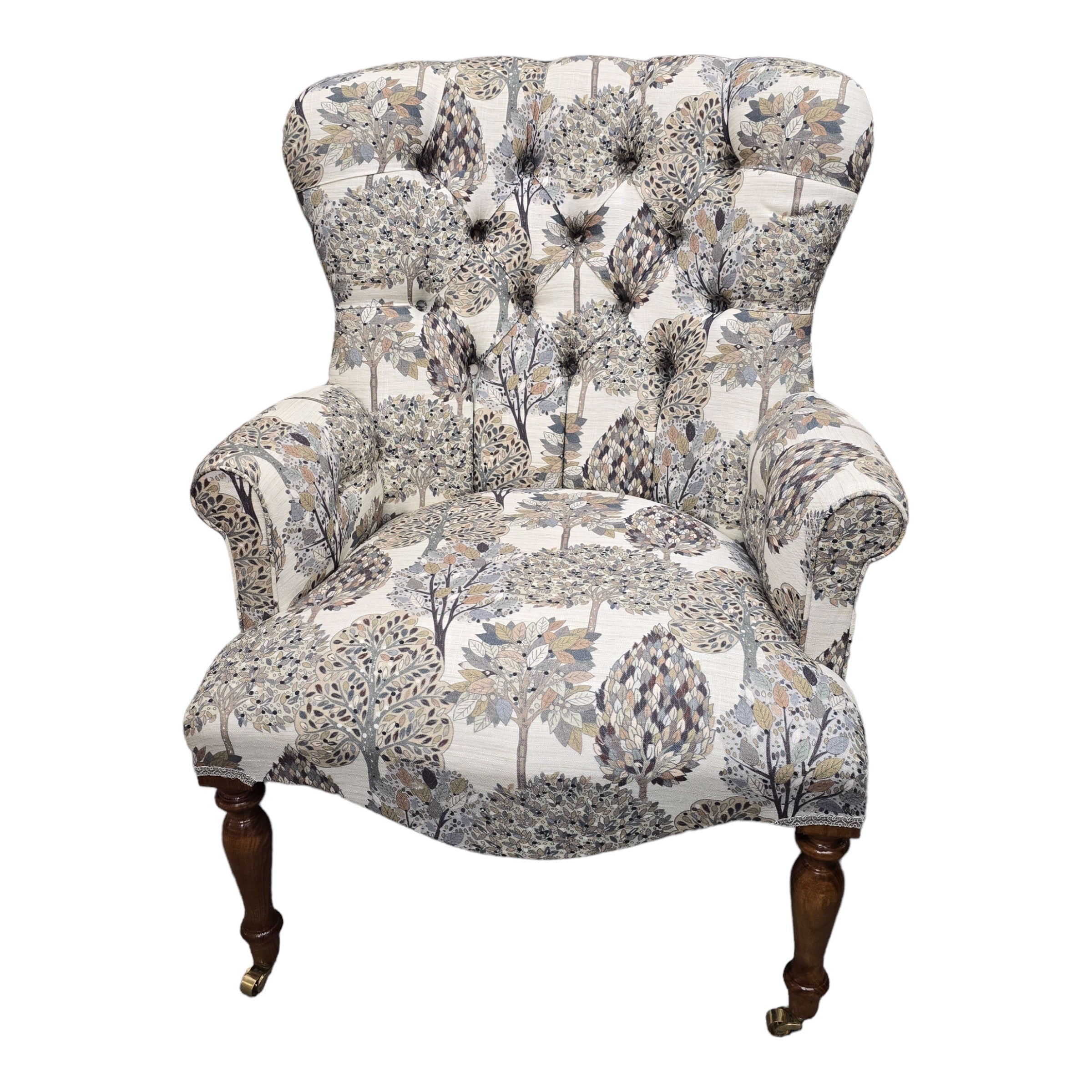 A hand-crafted occasional armchair covered in digitally printed cream cotton/linen blend fabric with a grey and beige tree design. 