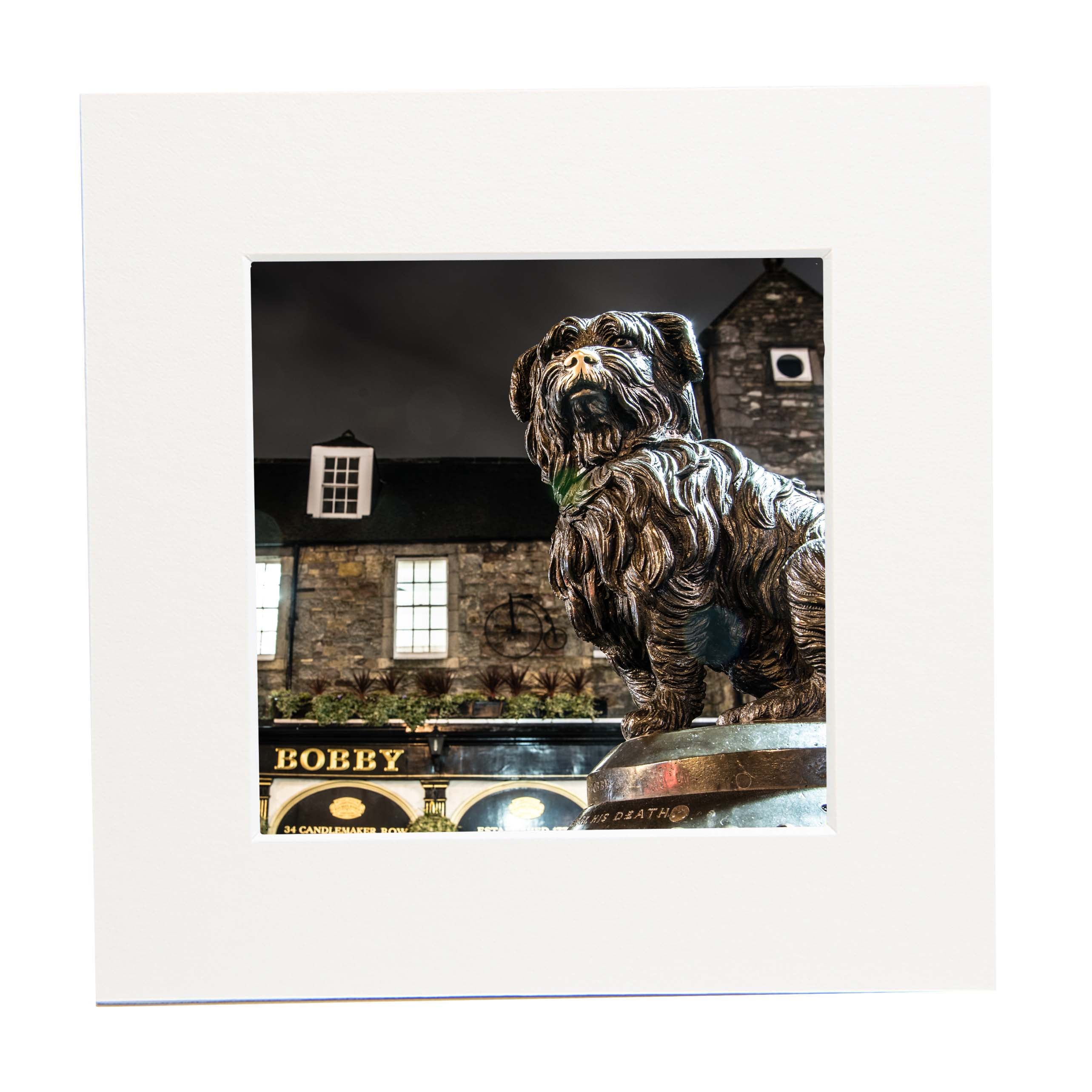 An image of the Greyfriars Bobby statue in a square mounted print. 