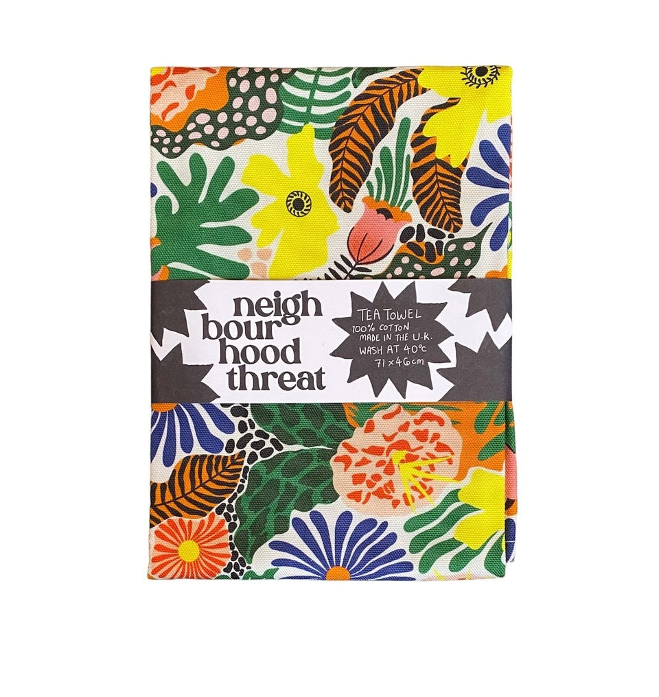 Tea towel featuring an illustration of colourful plants, flowers and leaves from the garden