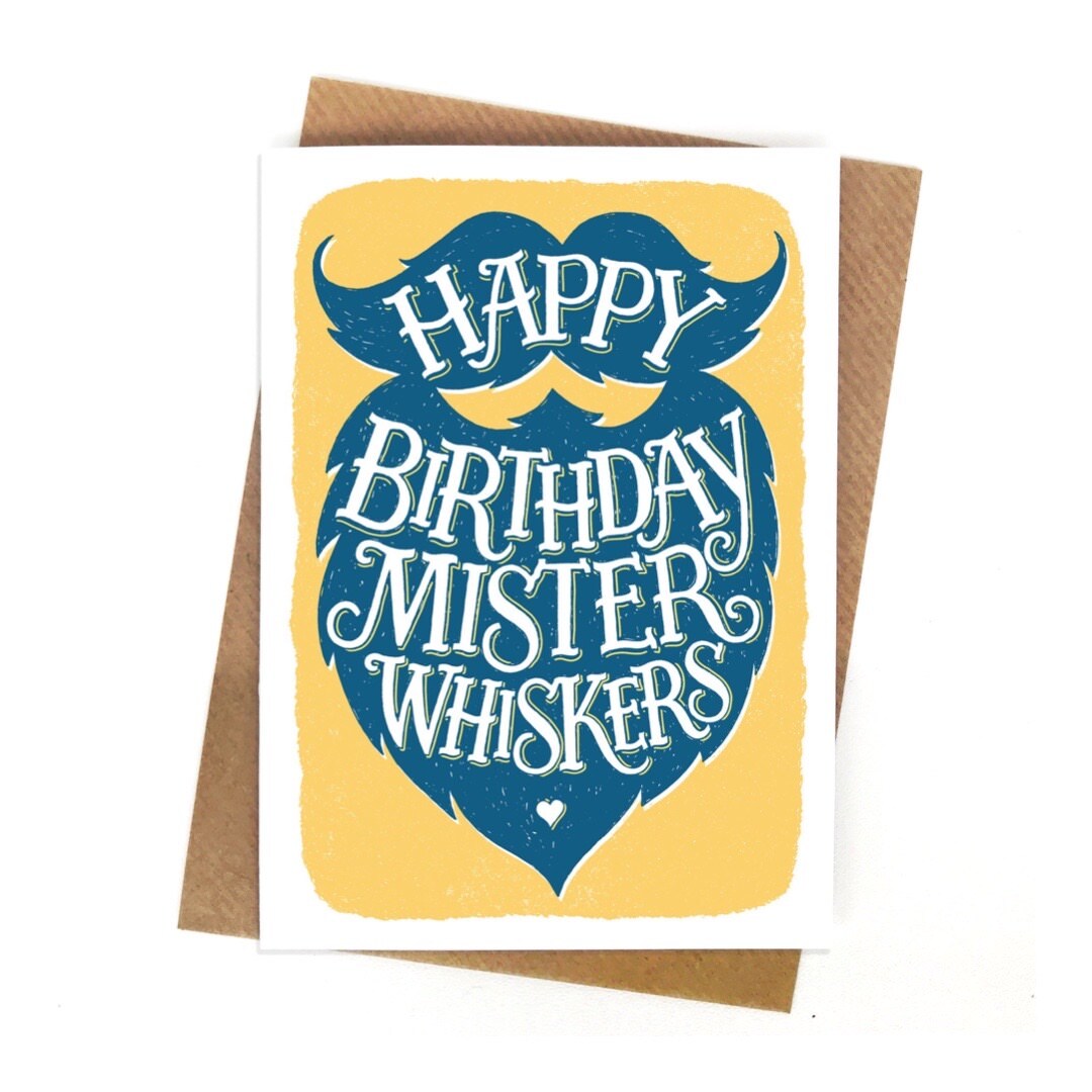 Birthday card featuring a blue beard and moustache with the text 'Happy Birthday Mister Whiskers' written inside in white lettering, all on a yellow background with a white border.