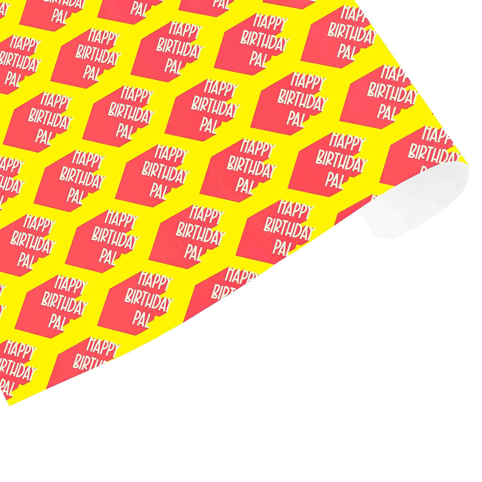 A piece of wrapping paper with a repeated pattern of text 'HAPPY BIRTHDAY PAL' in red on a yellow background.