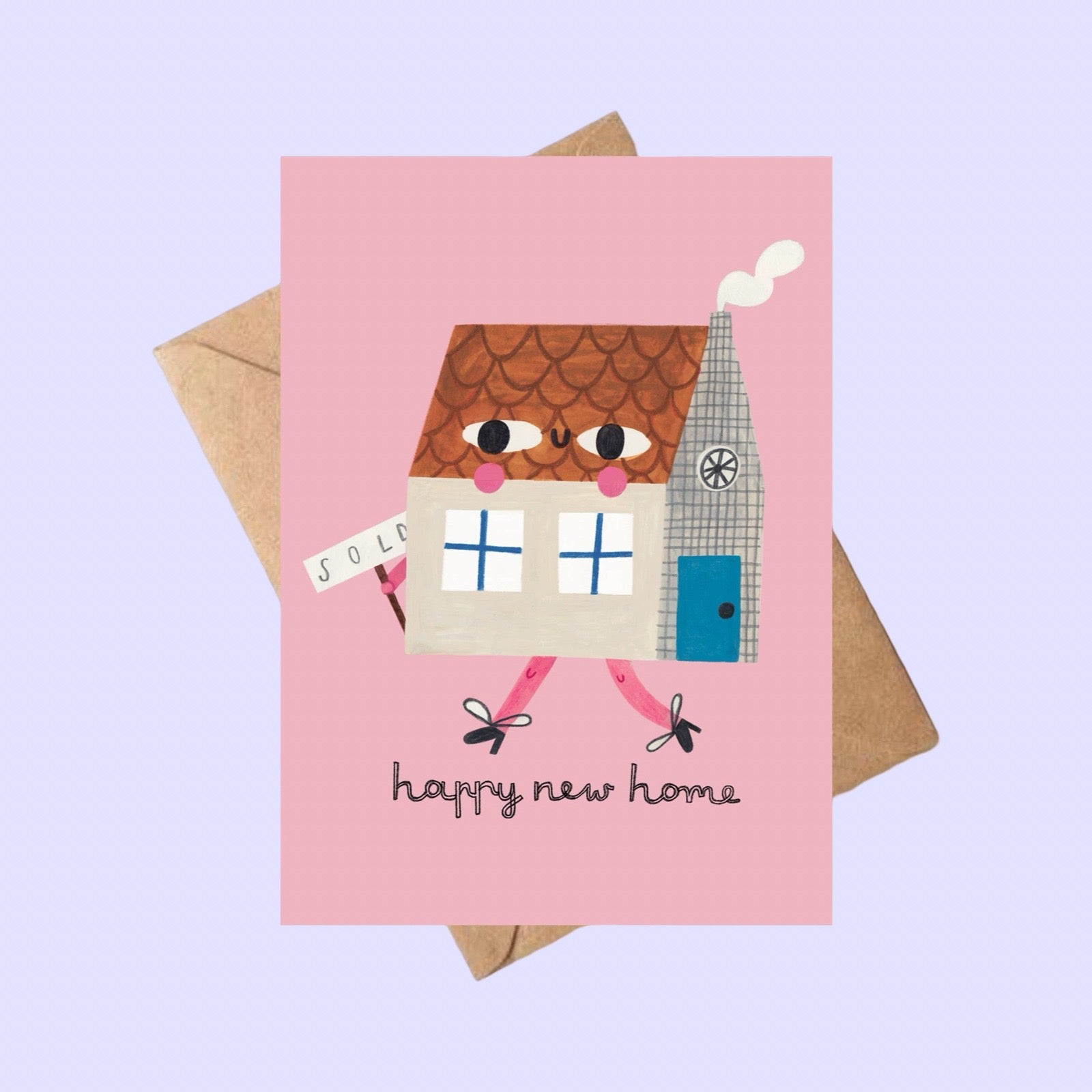 Greeting card with house illustration and 'happy new home' text on a pink background, on a brown envelope on a lilac background.