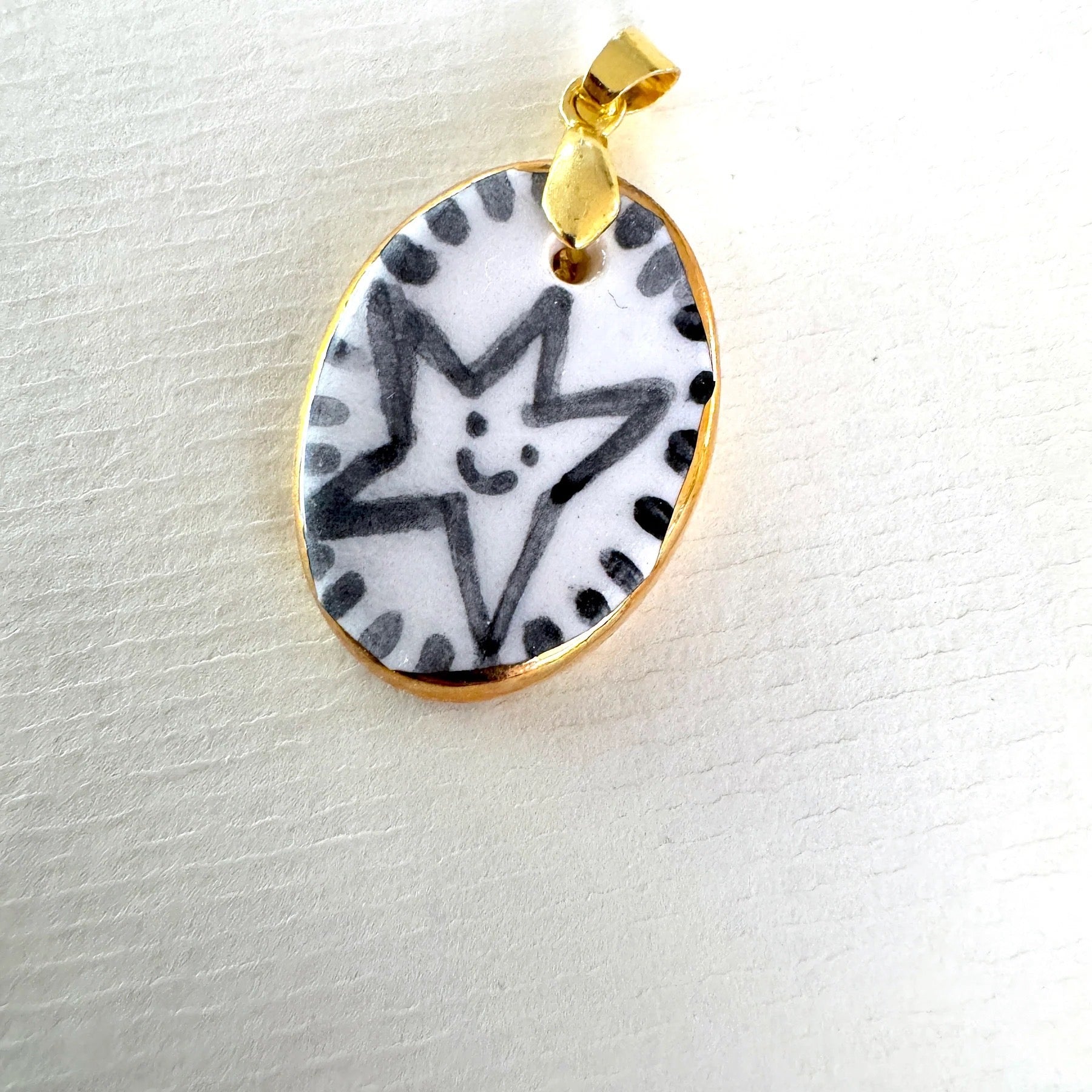 Pendant with star design on a white background.