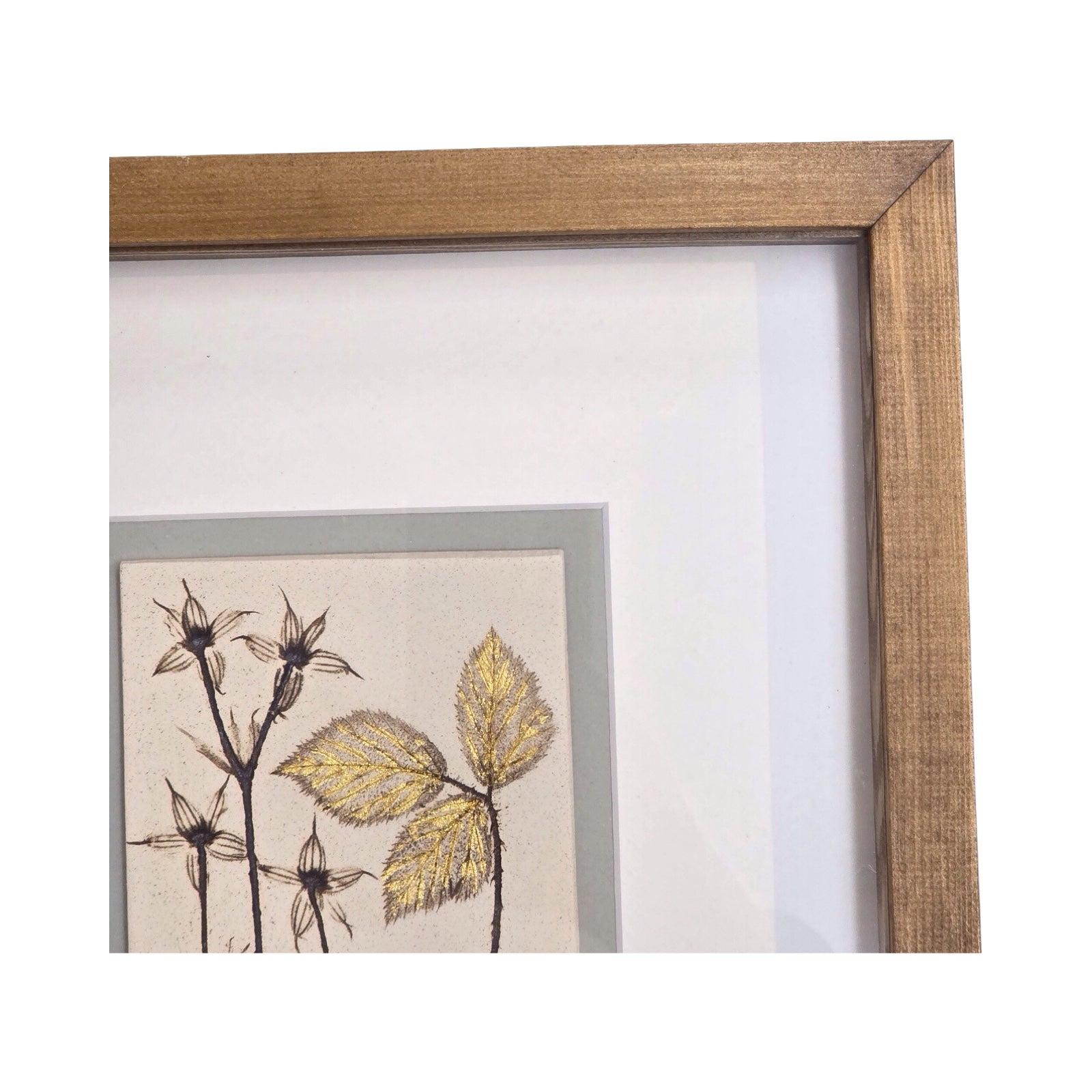 Framed botanical tile featuring hardy geranium in a wooden frame on a white background