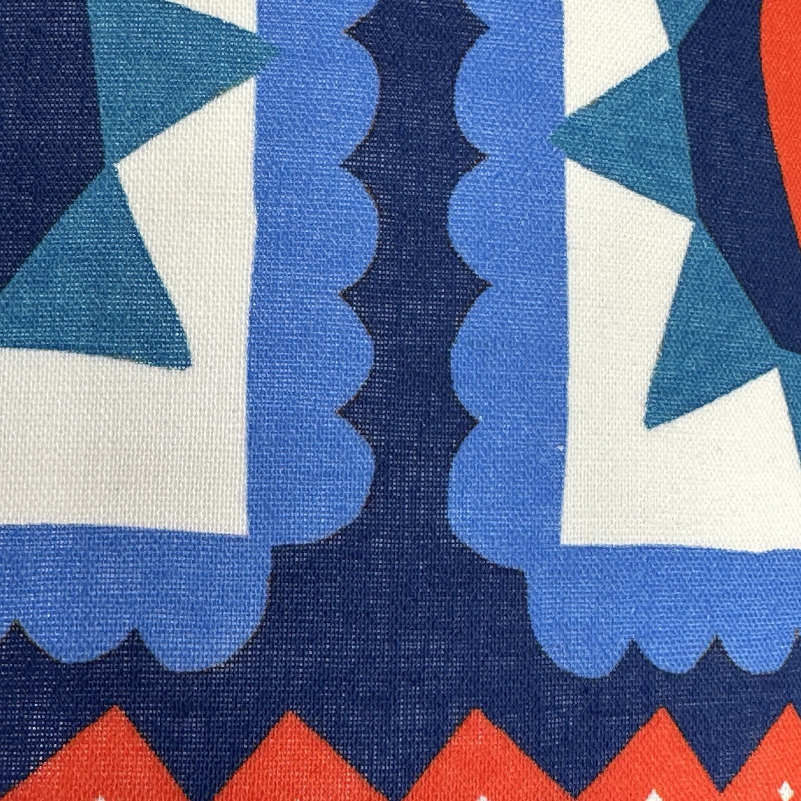 Close-up of fabric with geometric pattern in blue, red, and white