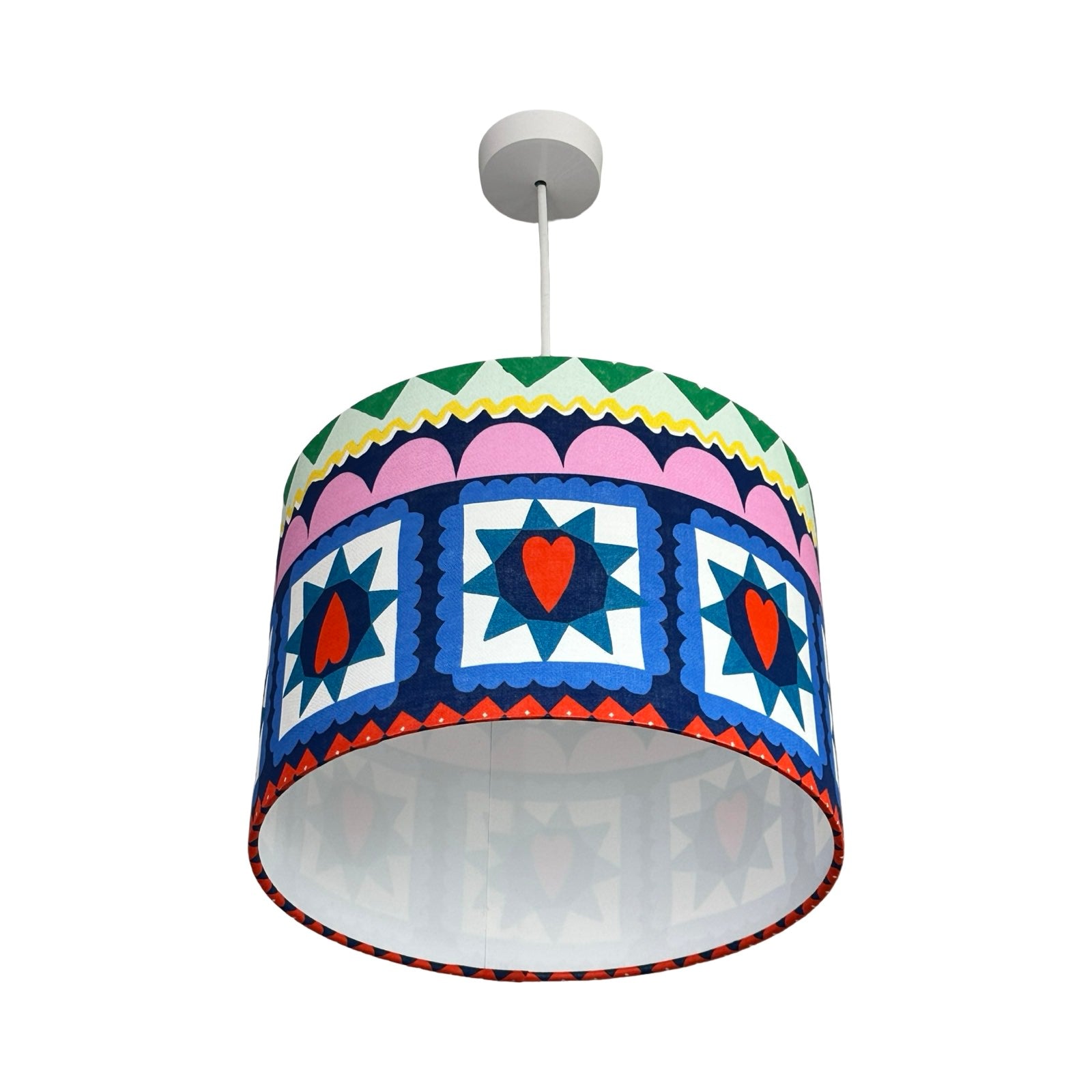 Colourful patterned lampshade on a white background.
