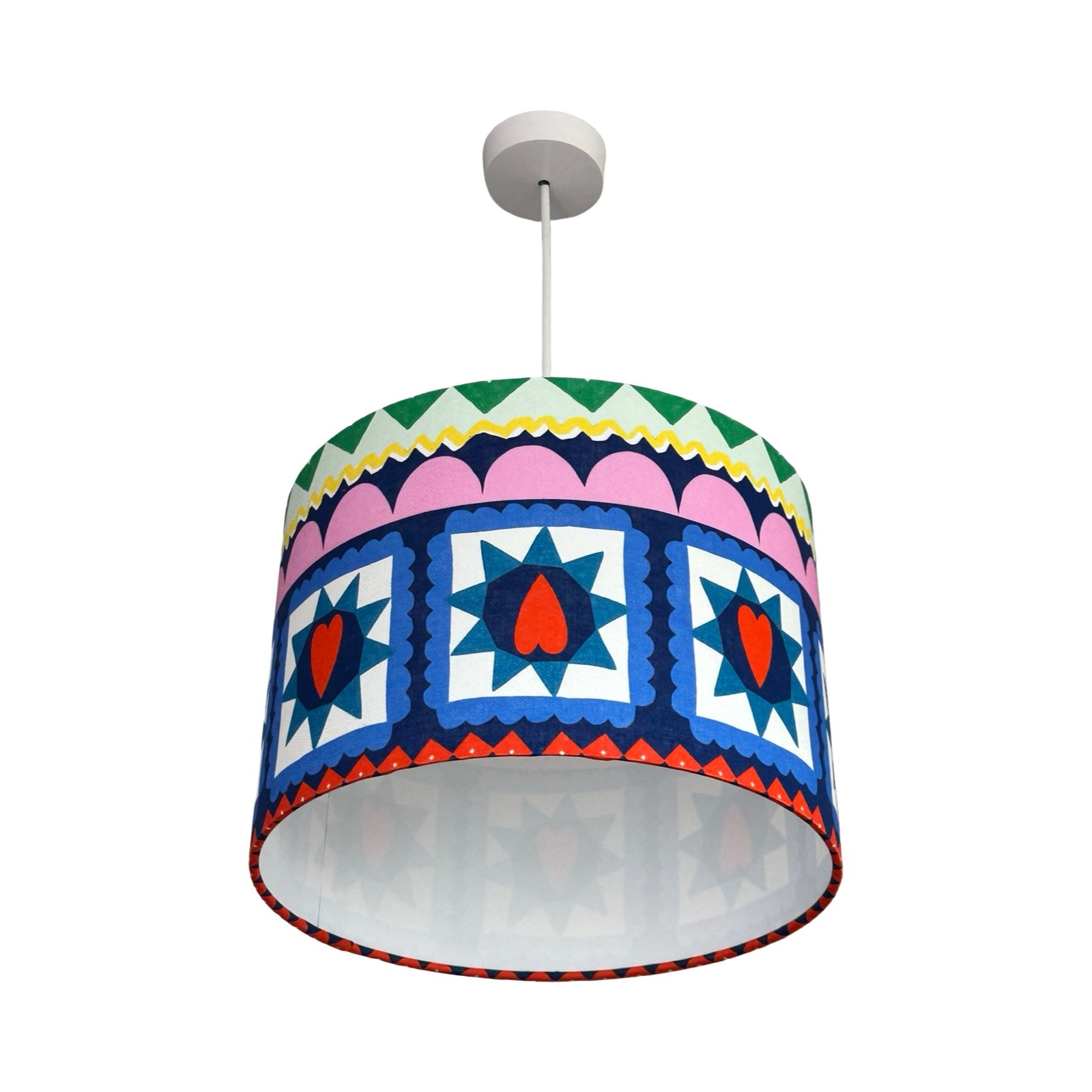 Colorful patterned lampshade on a white background.