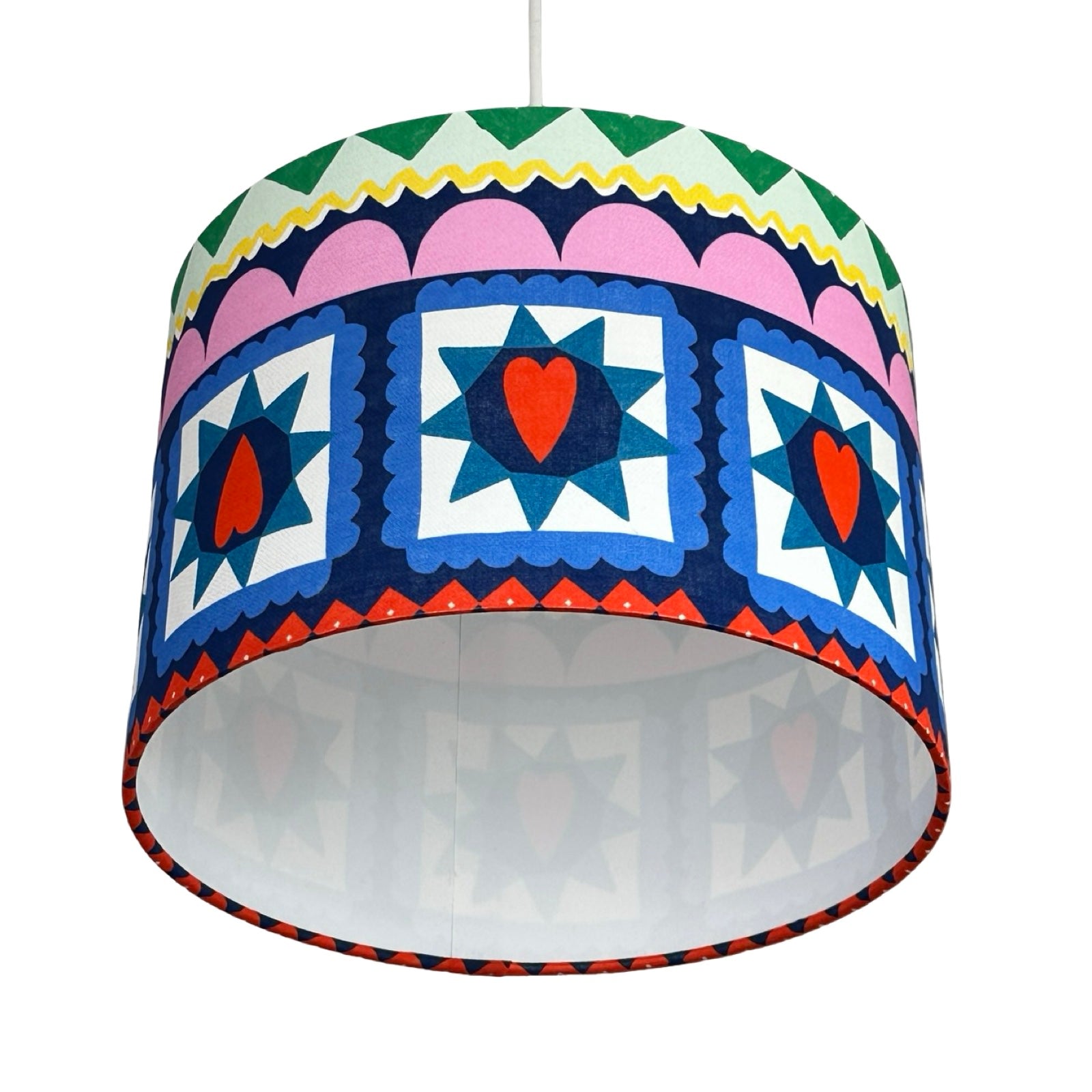 Colorful patterned lampshade with geometric design on a white background.