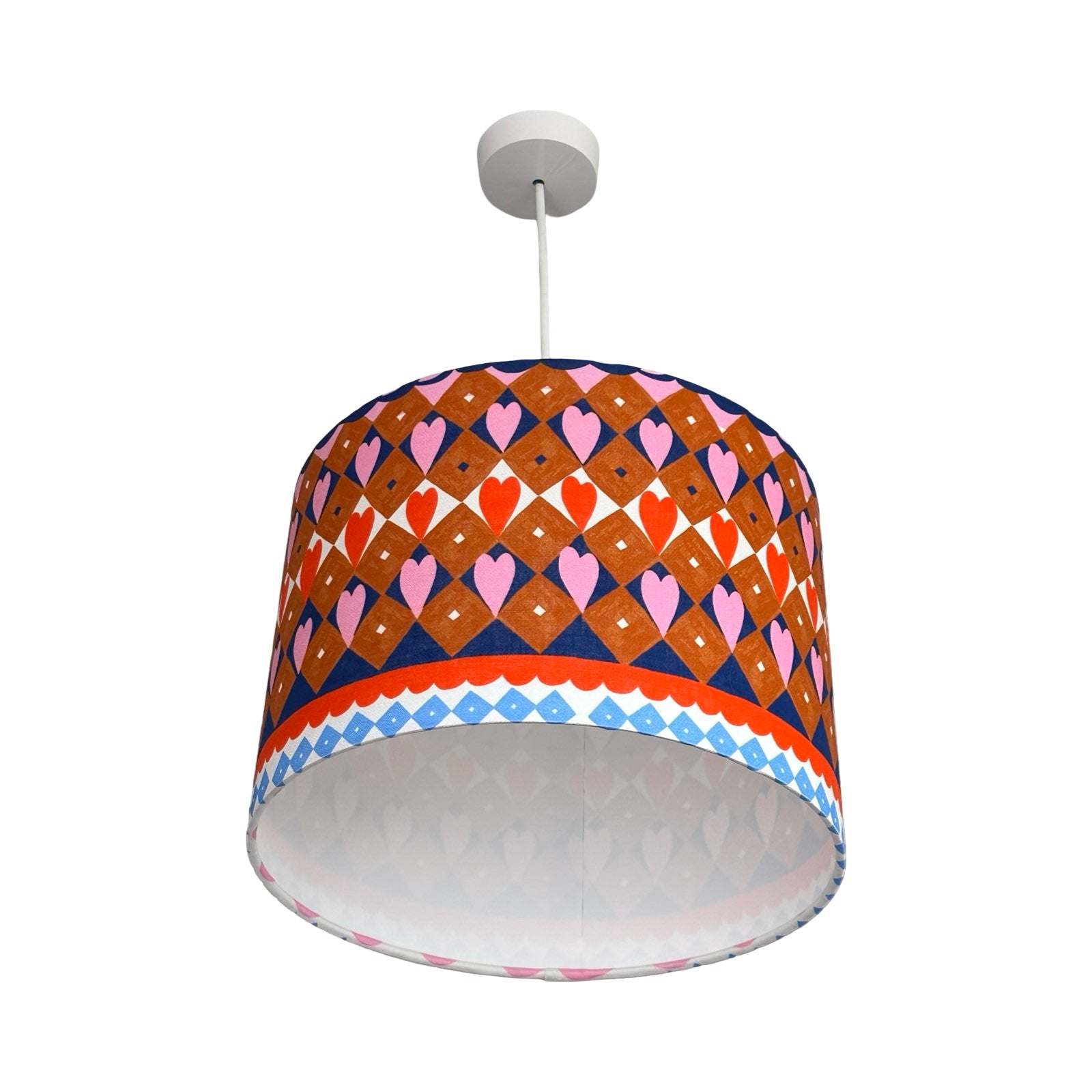 Colorful patterned lampshade on a white background.
