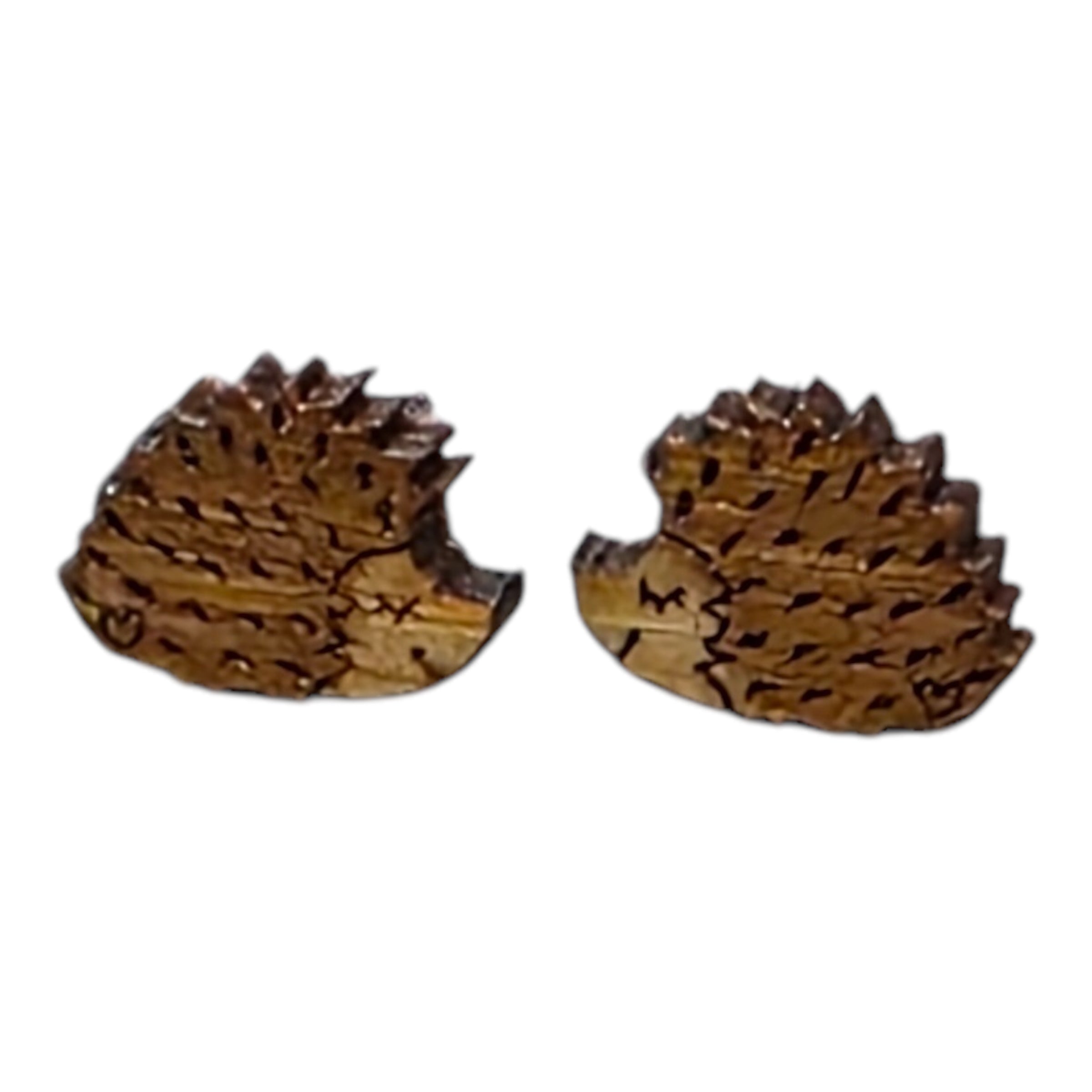 A pair of brown hedgehog-shaped wooden earrings.