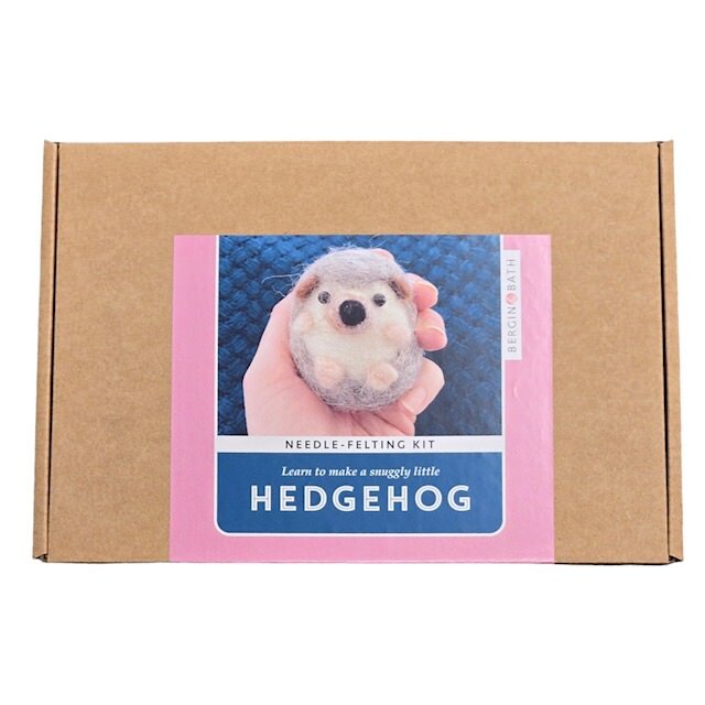 A brown box with a picture of a felted brown hedgehog