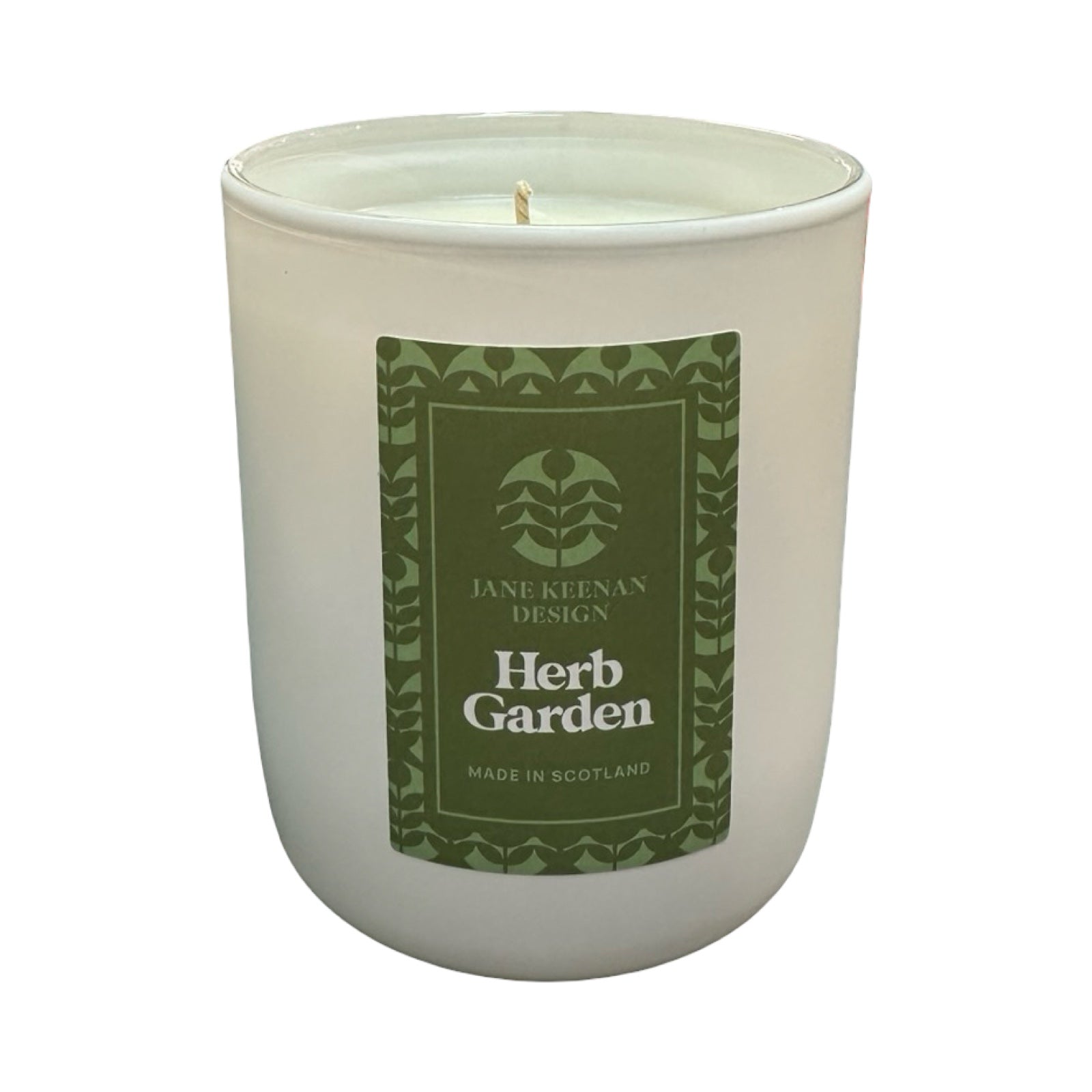 Candle in a white container with a green label on a white background.