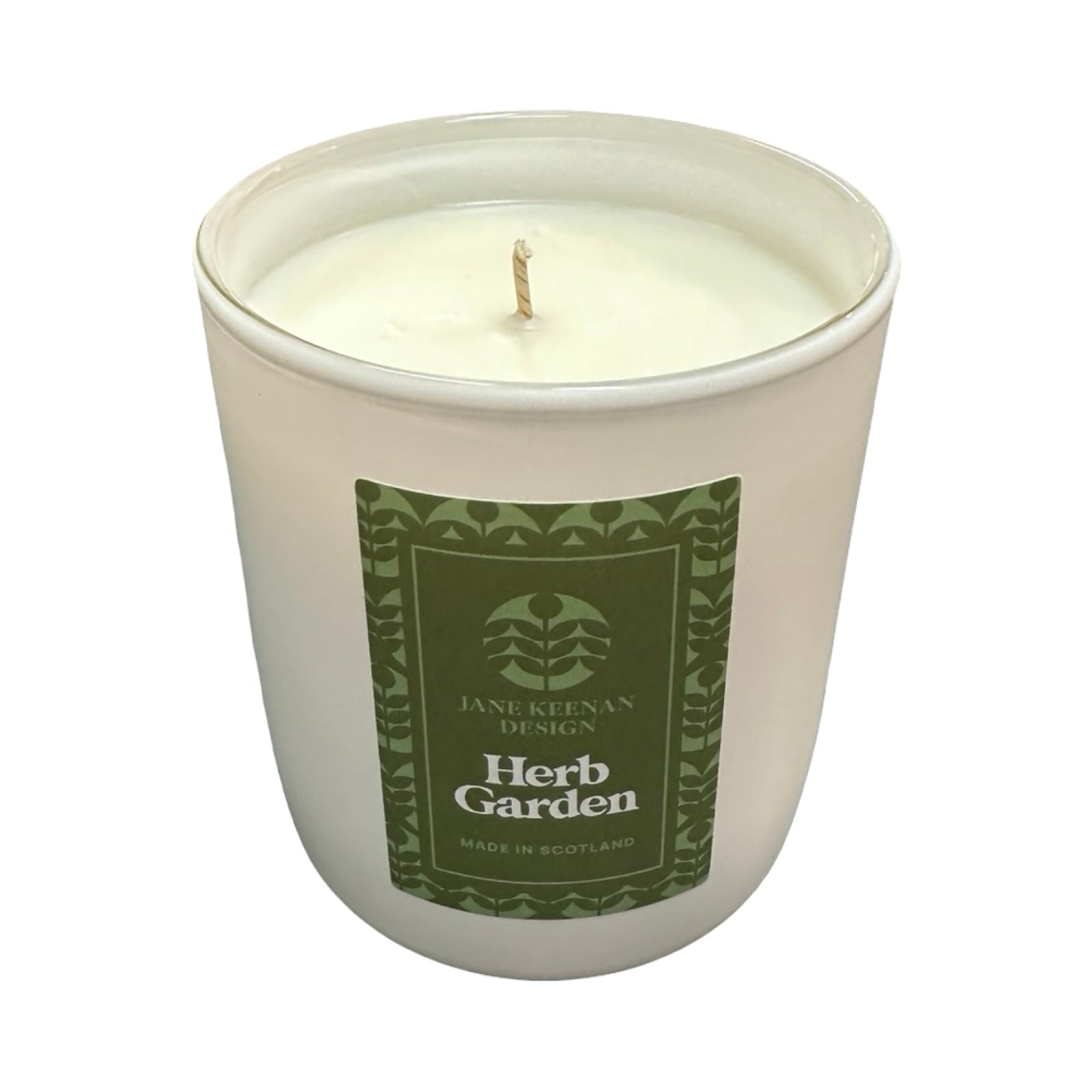 Candle in a white container with a green label on a white background.