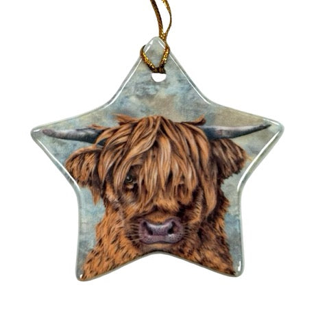 A star-shaped ceramic decoration featuring an illustration of the head of a highland cow.