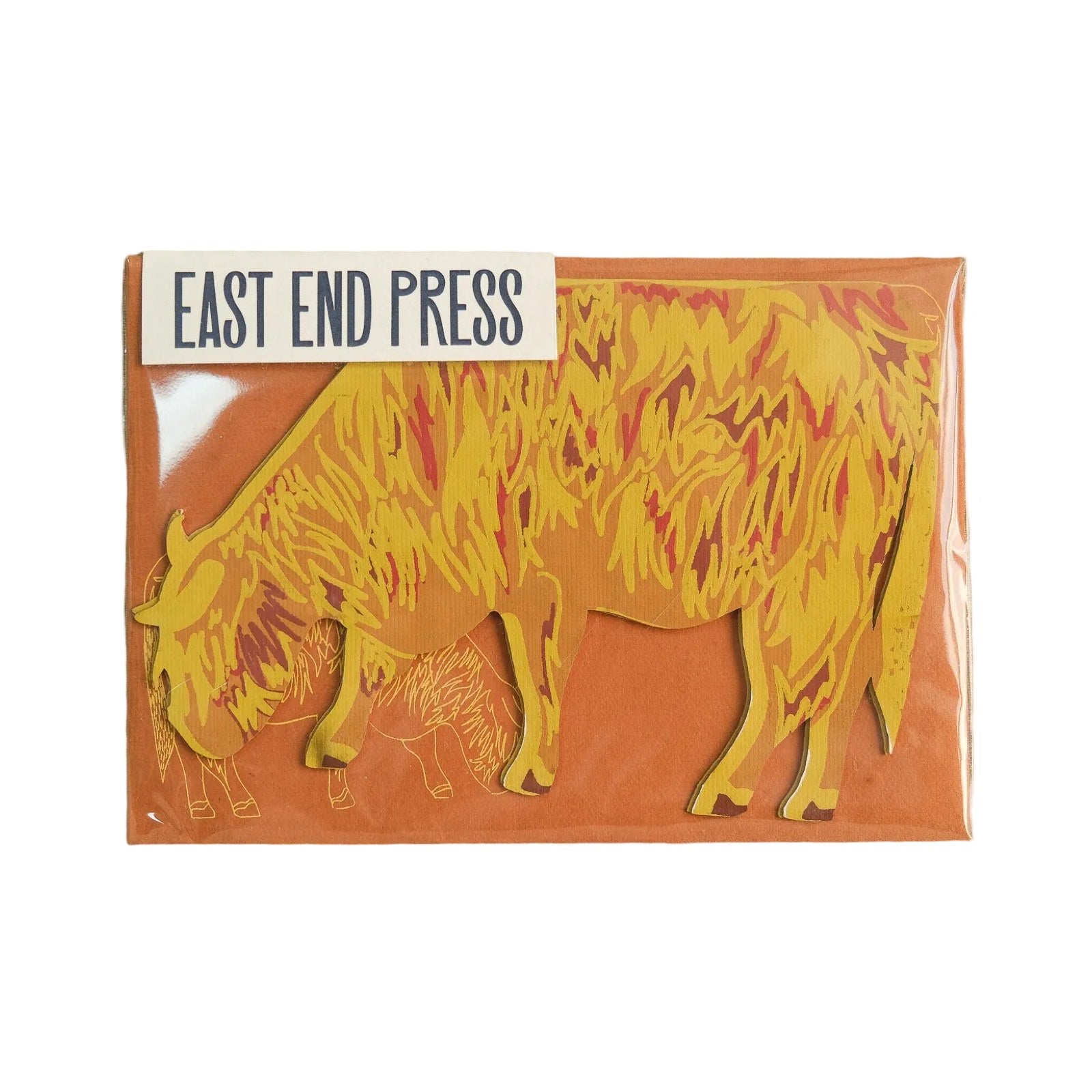A highland cow shaped card in brown, yellow and red with a brown envelope.