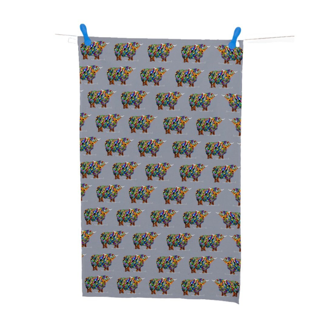 Grey tea towel featuring multiple bright-coloured highland cows.