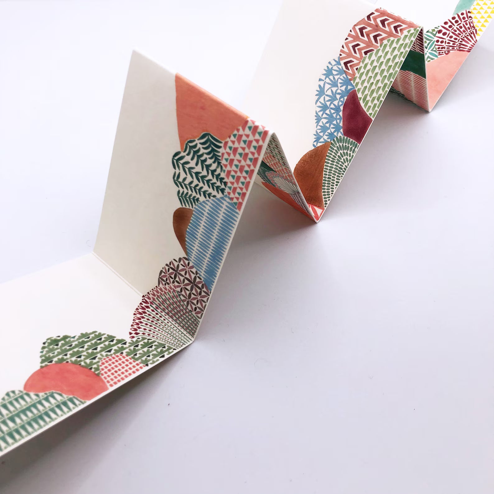 Colourful patterned card strip on a white background.