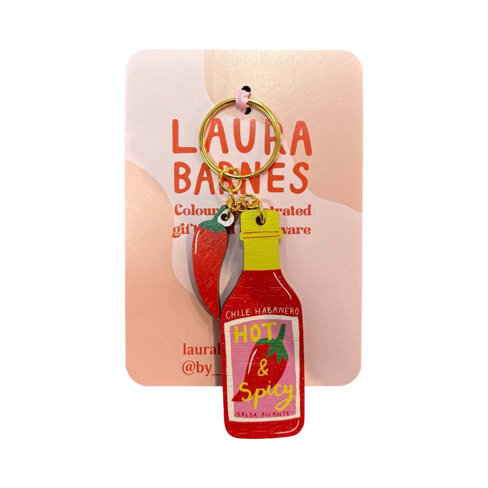 Keychain shaped like a chili sauce bottle with a card behind it, featuring 'Laura Barnes' branding.