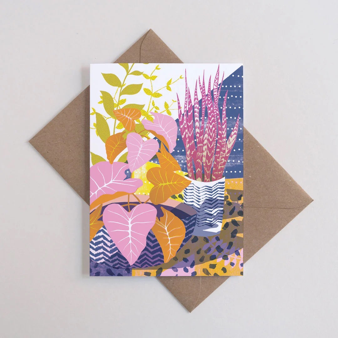 Colourful floral patterned card with a brown envelope on a light grey background.