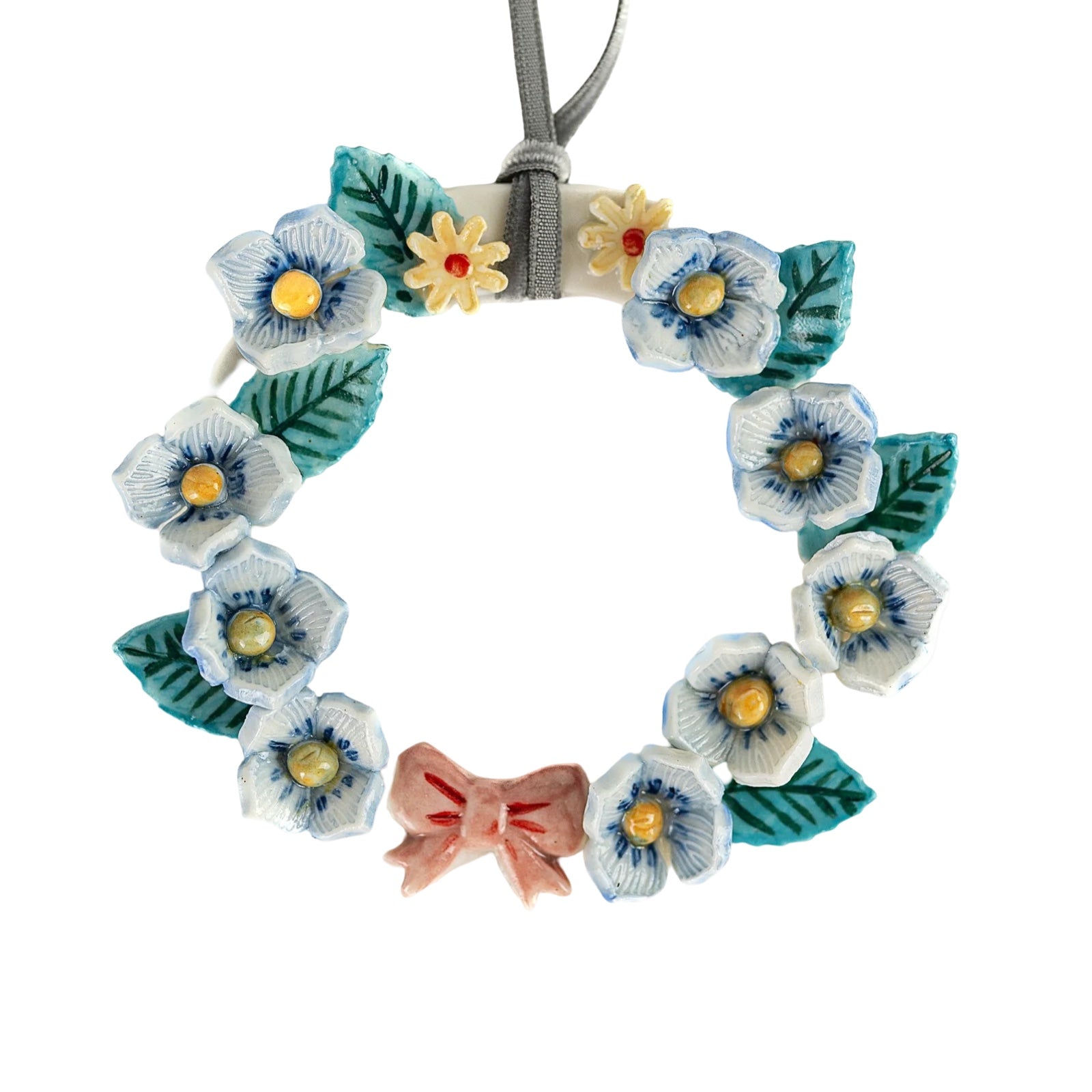 This gorgeous handmade porcelain folk-inspired bird is hand-painted in a colourful design that includes small red daisies and red tulips. 