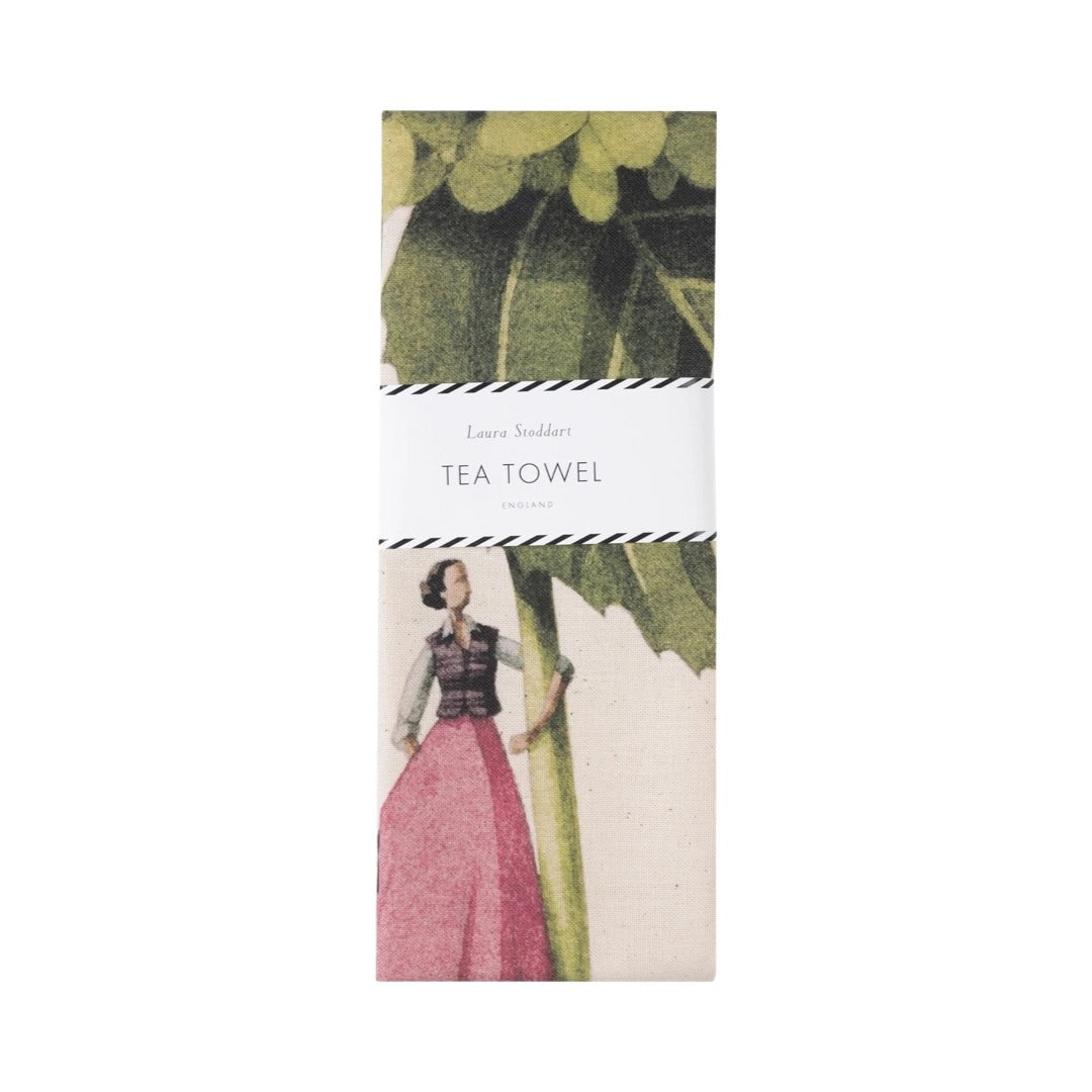 Folded tea towel featuring an illustration of a lady dressed in a pink dress holding a giant hydrangea.