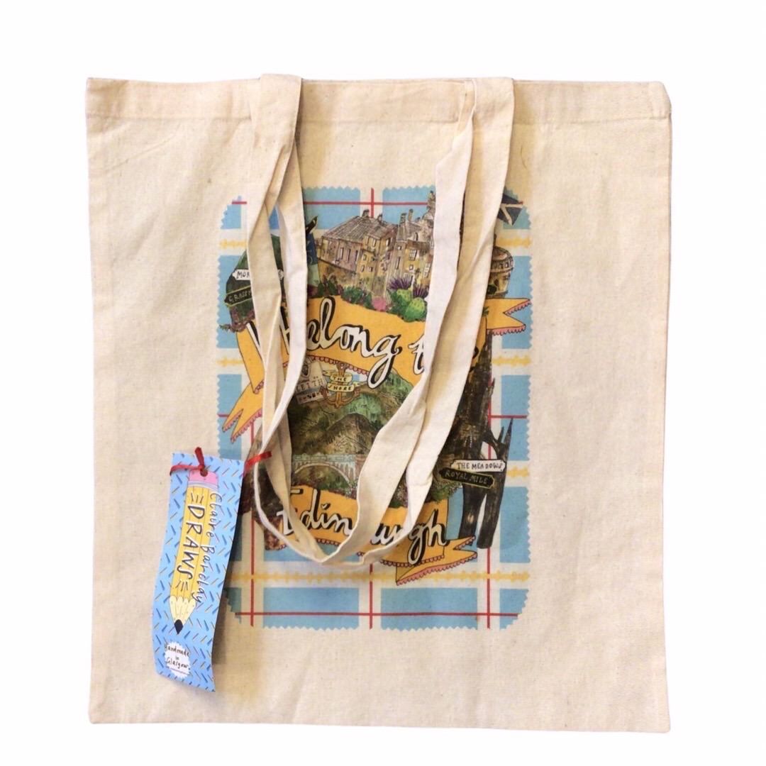 Tote bag featuring the text 'I Belong to Edinburgh' written inside a yellow banner and surrounded by illustrations of Edinburgh castle and other Edinburgh landmarks.