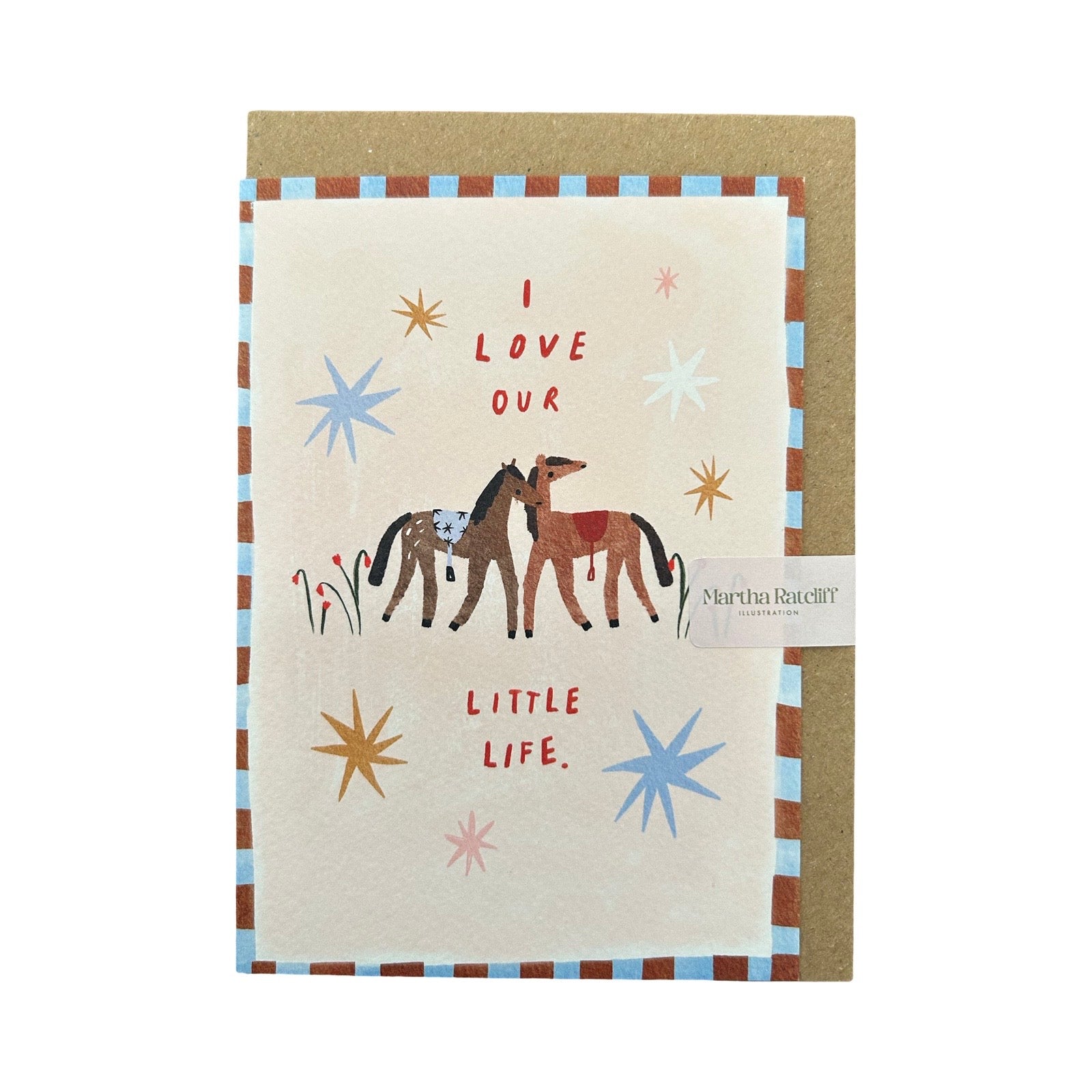 Card with two horses and text 'I love our little life' on a pink background, with a brown envelope.