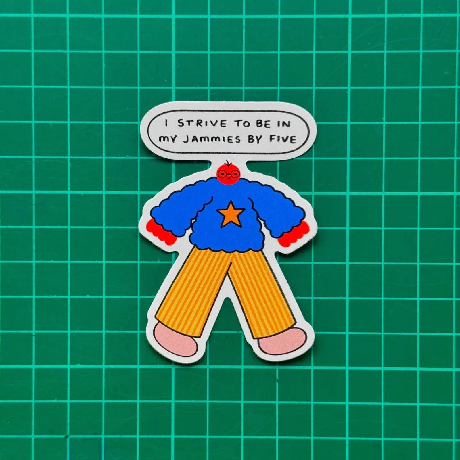 Cartoon character sticker with a blue sweater and yellow pants and a text bubble on a green grid background.